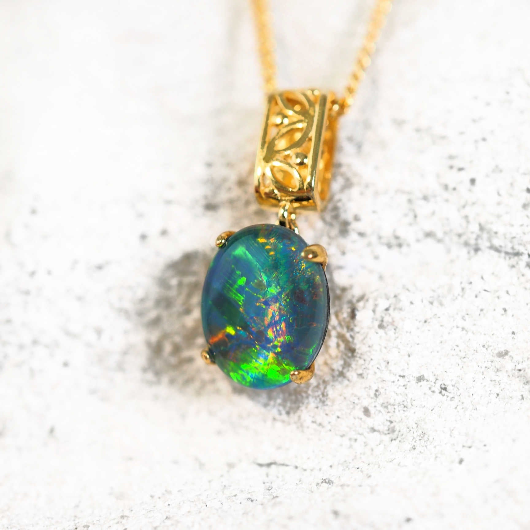 Gold-plated silver filigree barrel drop pendant with oval Australian triplet opal on matching chain
