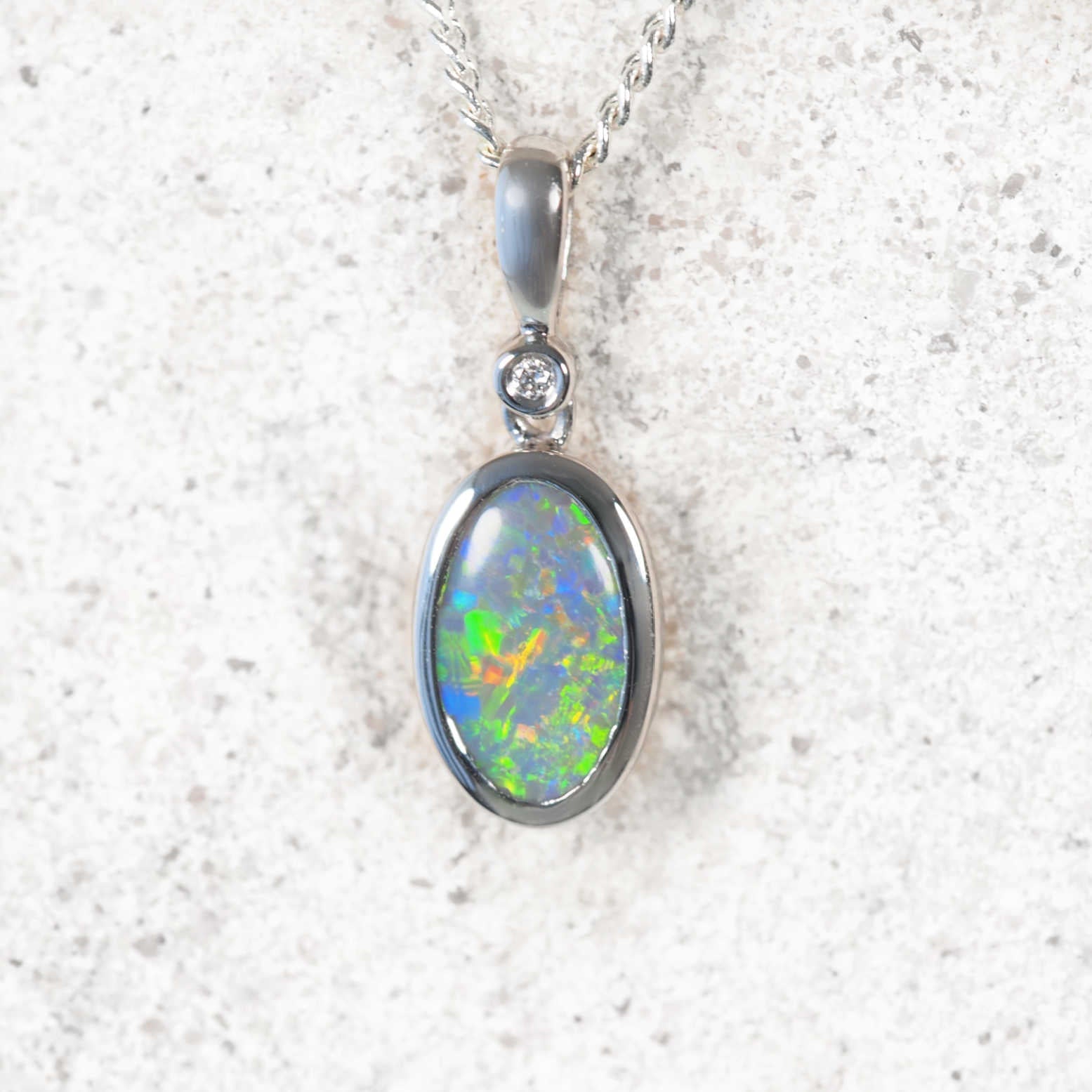 Elyra black opal pendant in 14ct white gold with oval Lightning Ridge semi-black opal and diamond accent