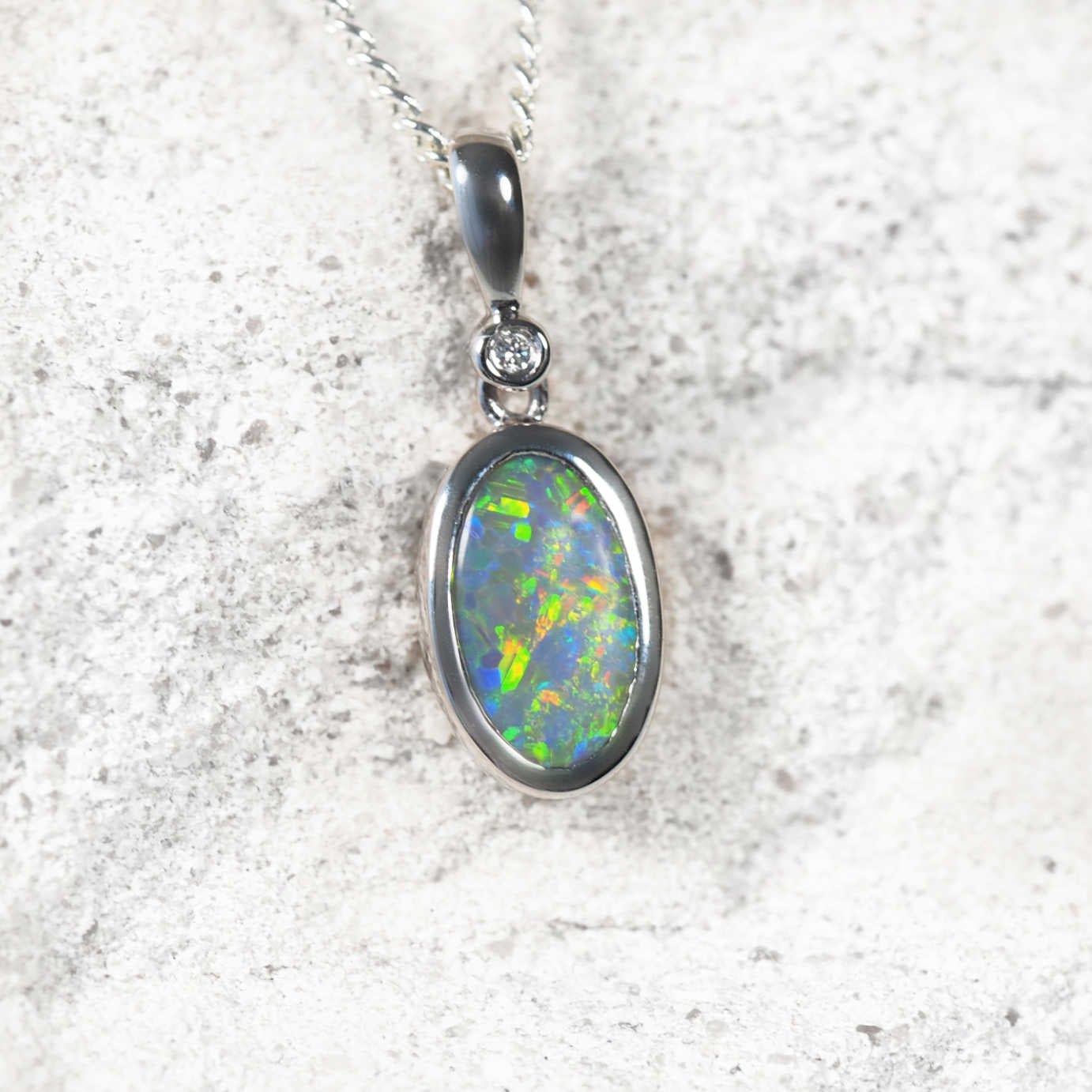 Luxury Australian black opal necklace featuring bezel-set Lightning Ridge opal with multi-colour floral flashes