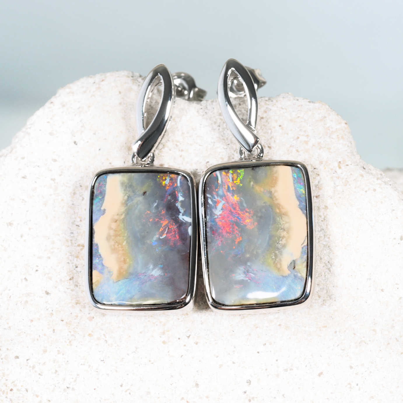 Ember Stone boulder opal earrings with red colourful hues set in sterling silver.