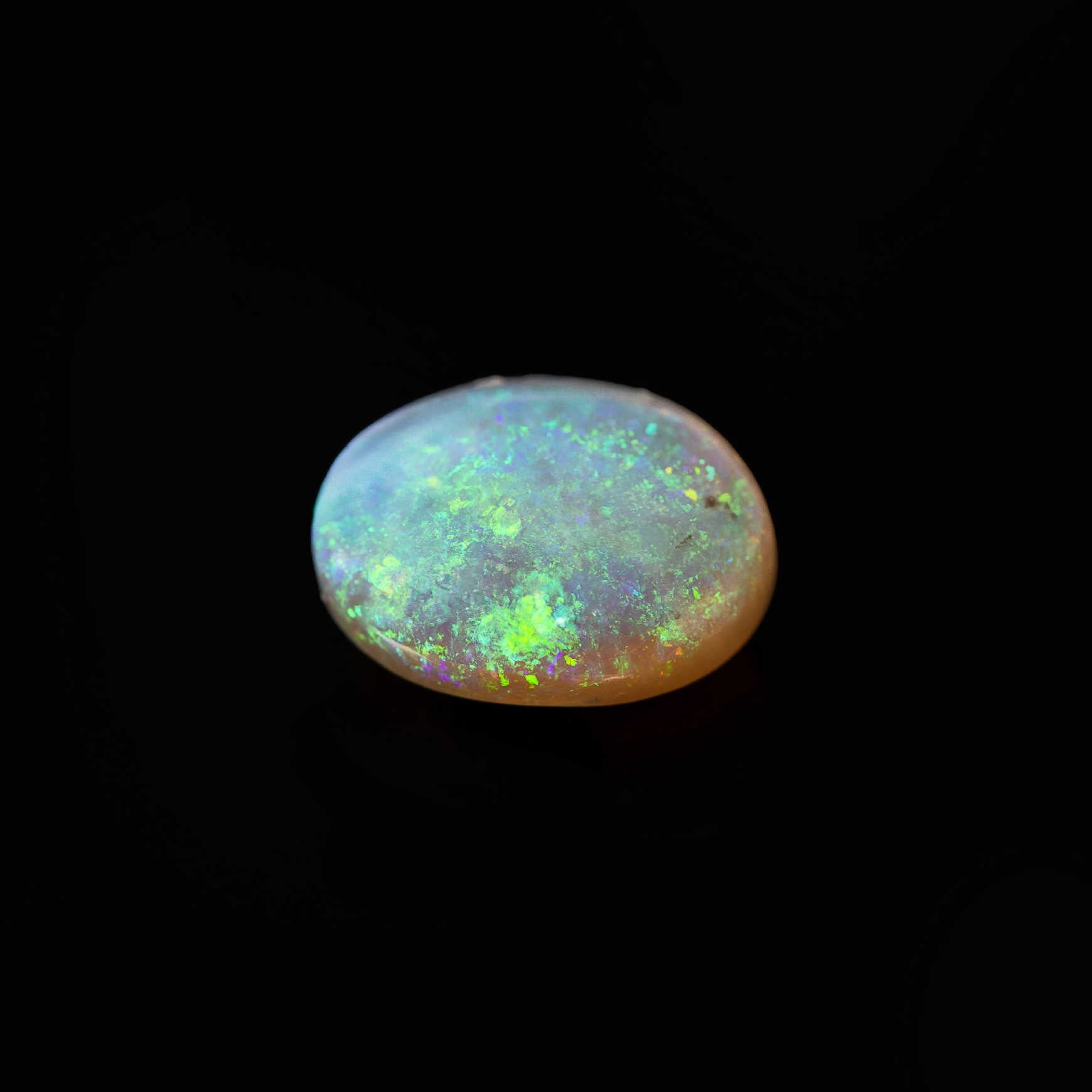 Natural Lightning Ridge opal with transparent body tone and green play-of-colour