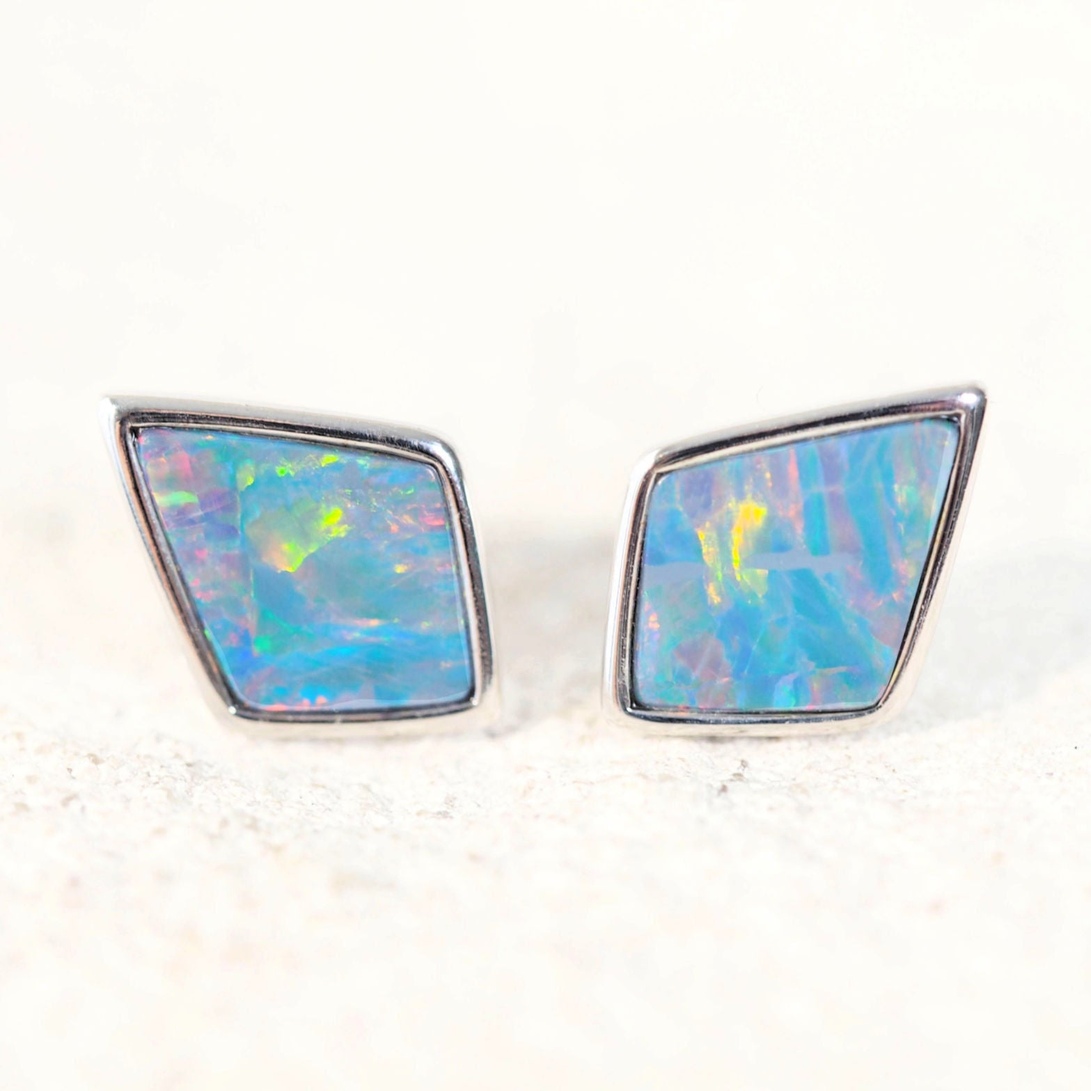 opal earrings set in silver studs