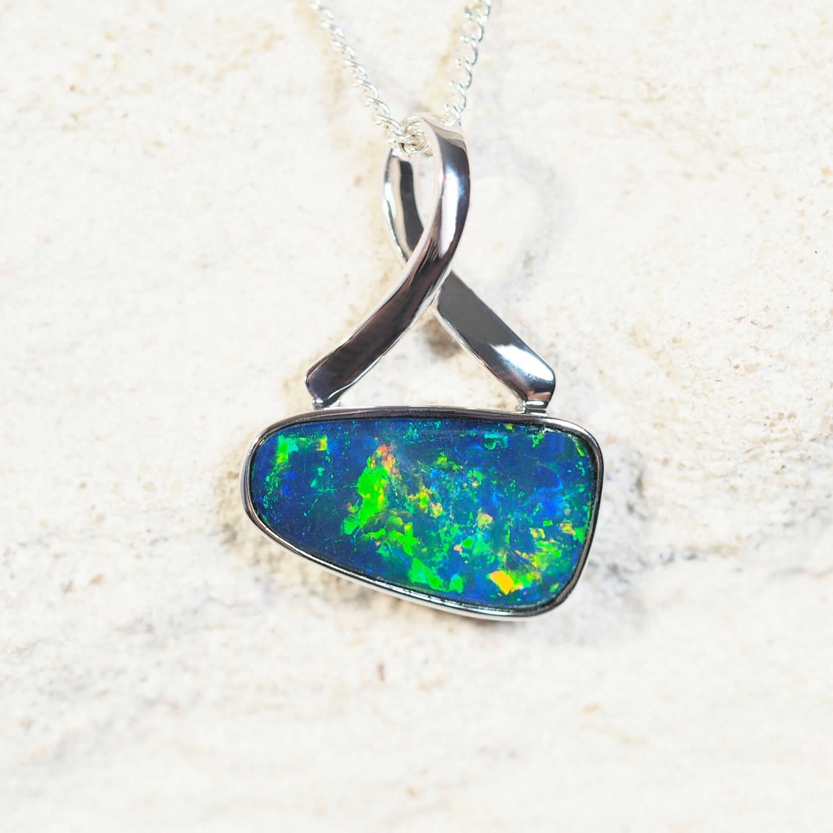 Evalina opal pendant in 14ct white gold featuring a blue-and-green Australian doublet opal with yellow and red highlights.