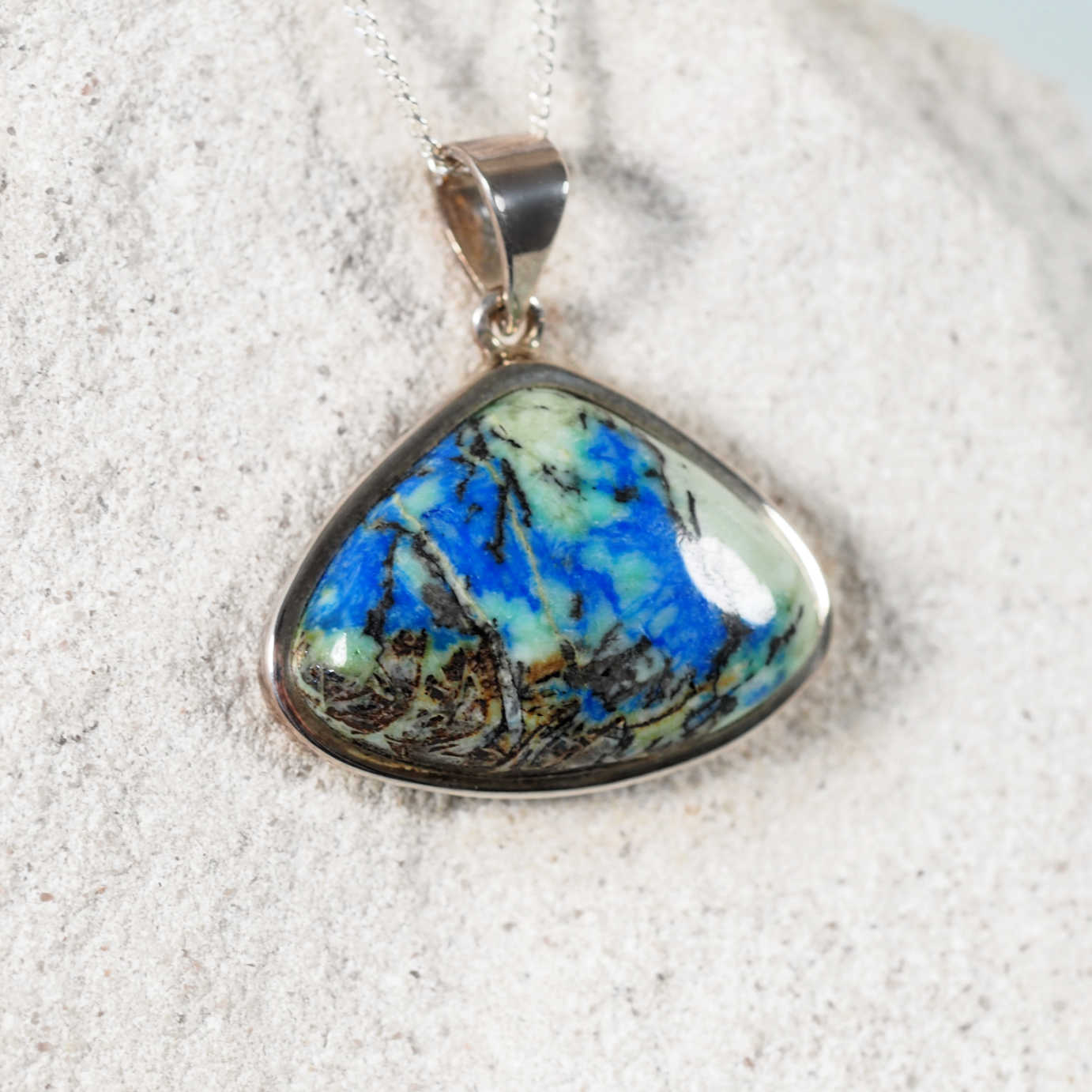 Close-up of 'Faye' Azurite/Chrysocolla pendant highlighting the stone’s vibrant color in a silver frame