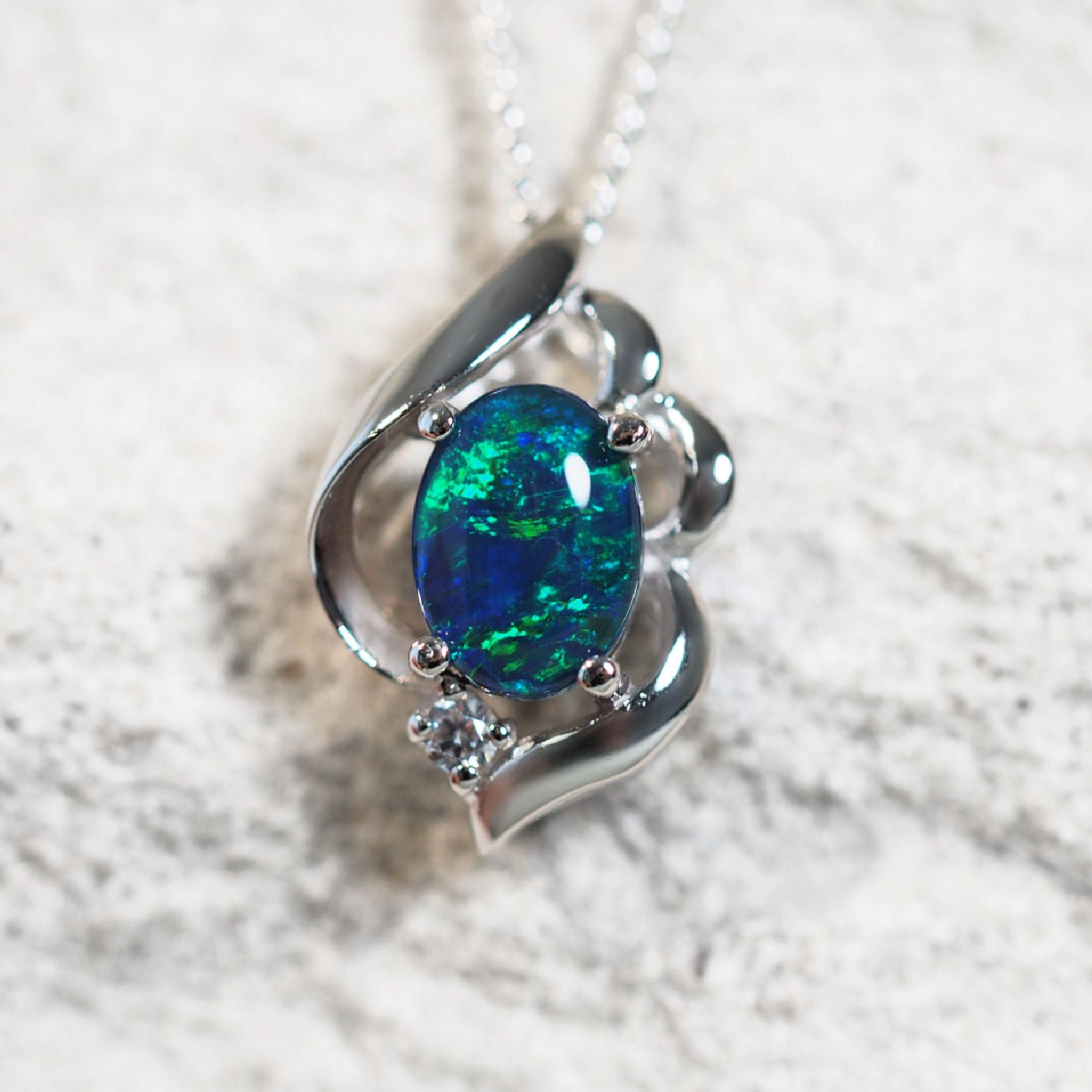 'Felia Blue' opal pendant in sterling silver with claw-set oval Australian triplet opal and sparkling cubic zirconia accent