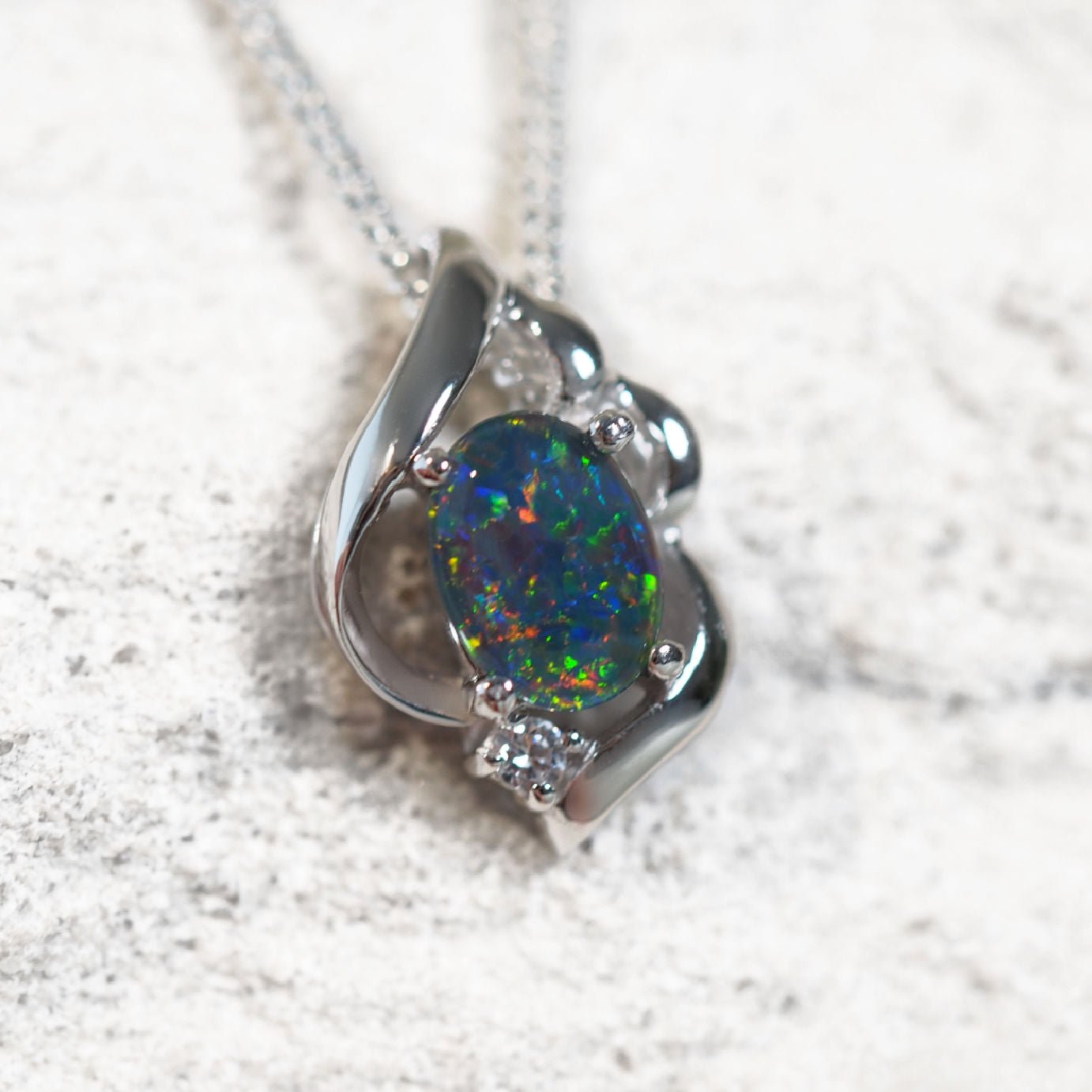 Elegant silver necklace pendant featuring multi-coloured Australian triplet opal with cubic zirconia detail – Felia design