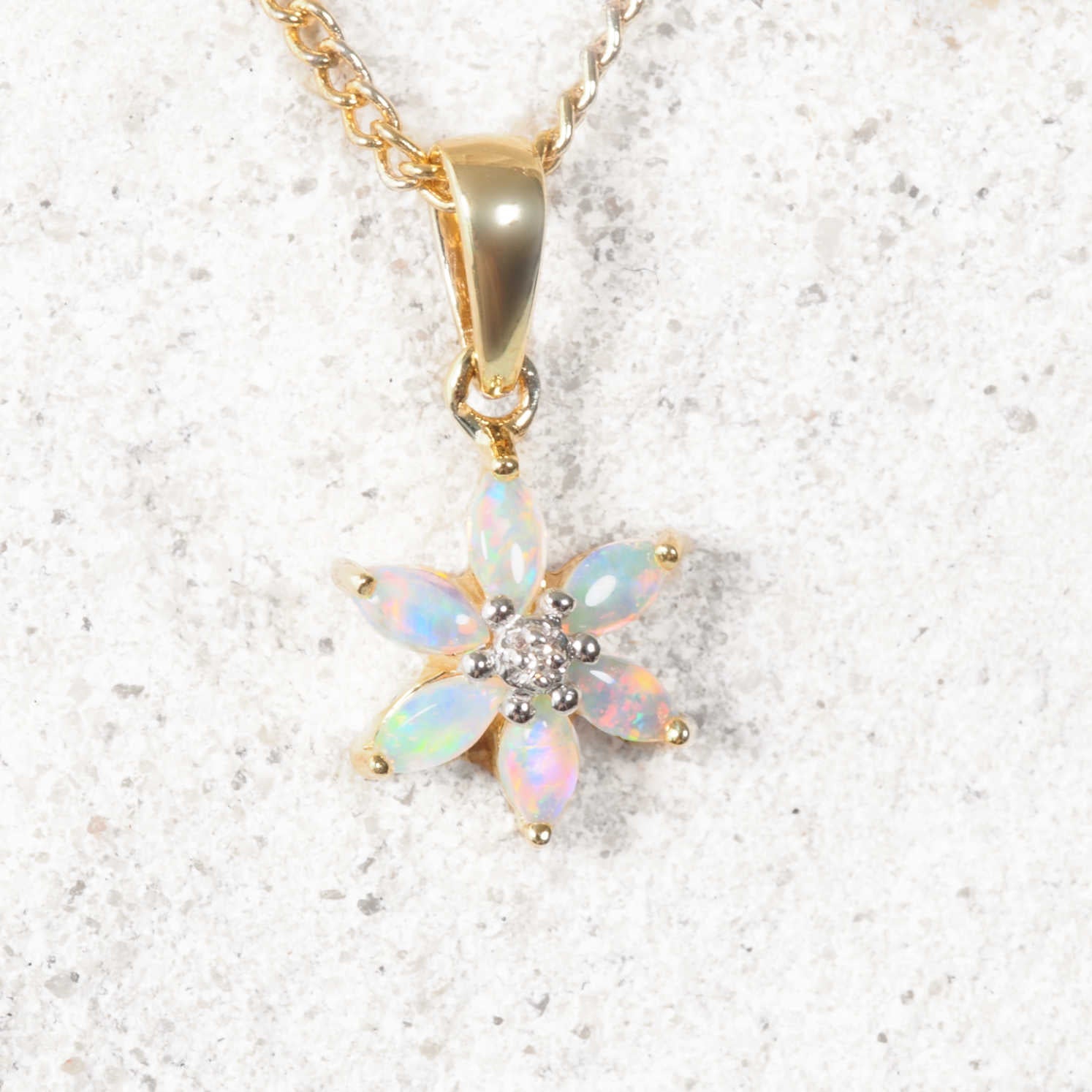 Opal flower pendant necklace on a light background