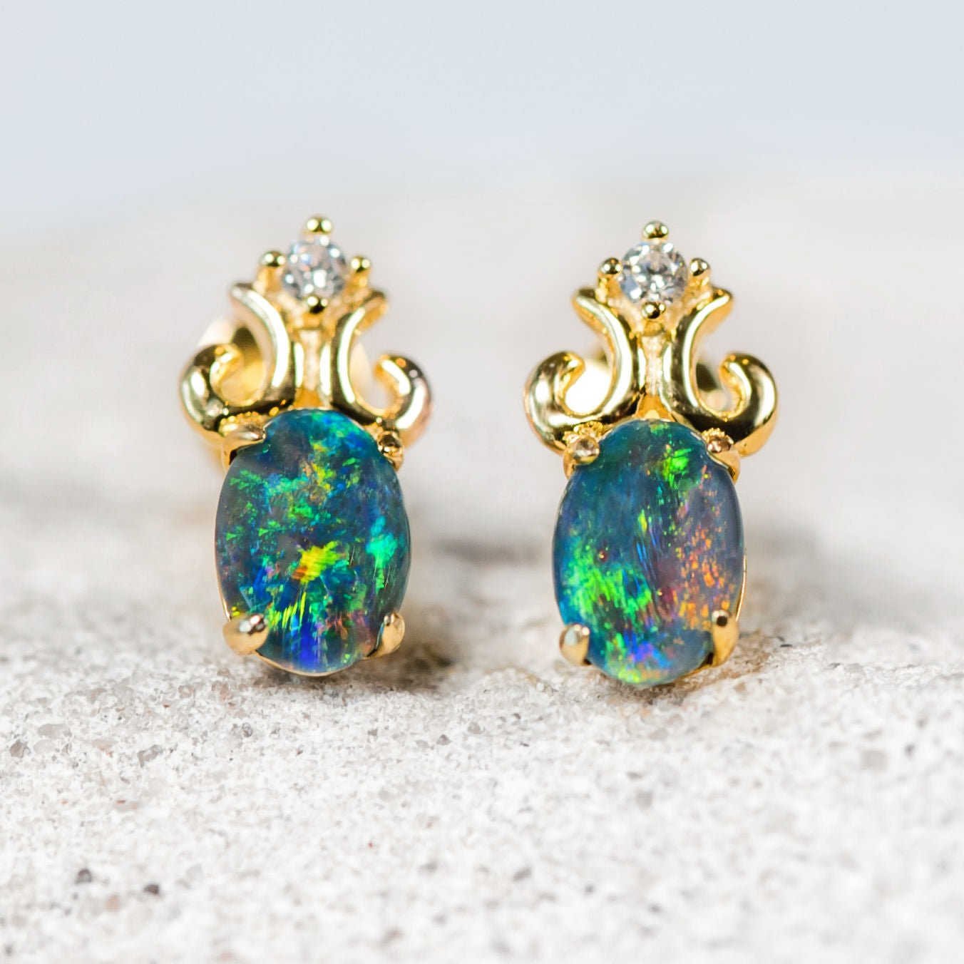 opal stud earrings with an intricate design and diamantes