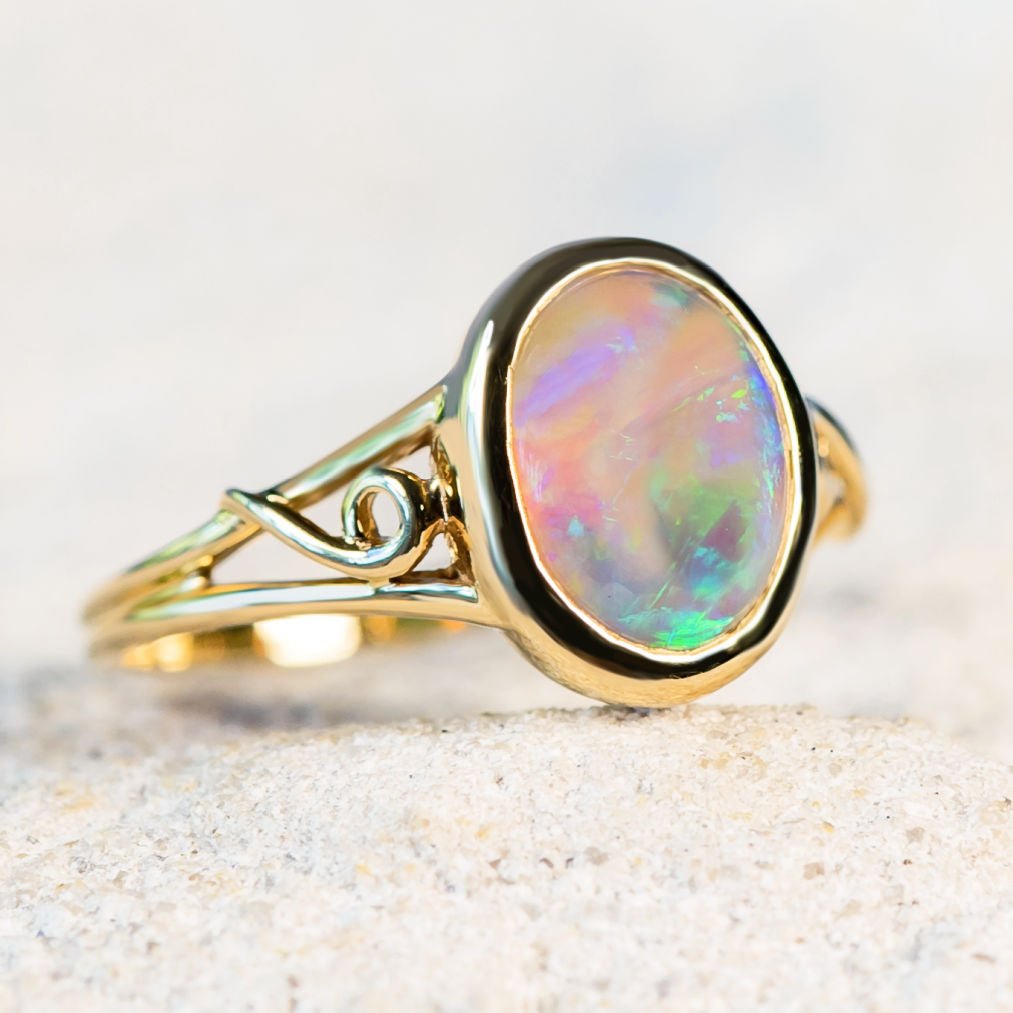 opal ring set with a blue and green crystal opal