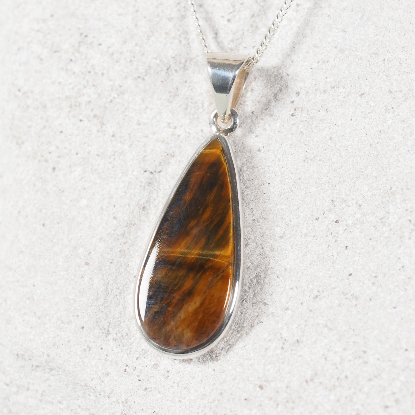Brown Tiger’s Eye pendant featuring refined bezel setting and natural silky sheen