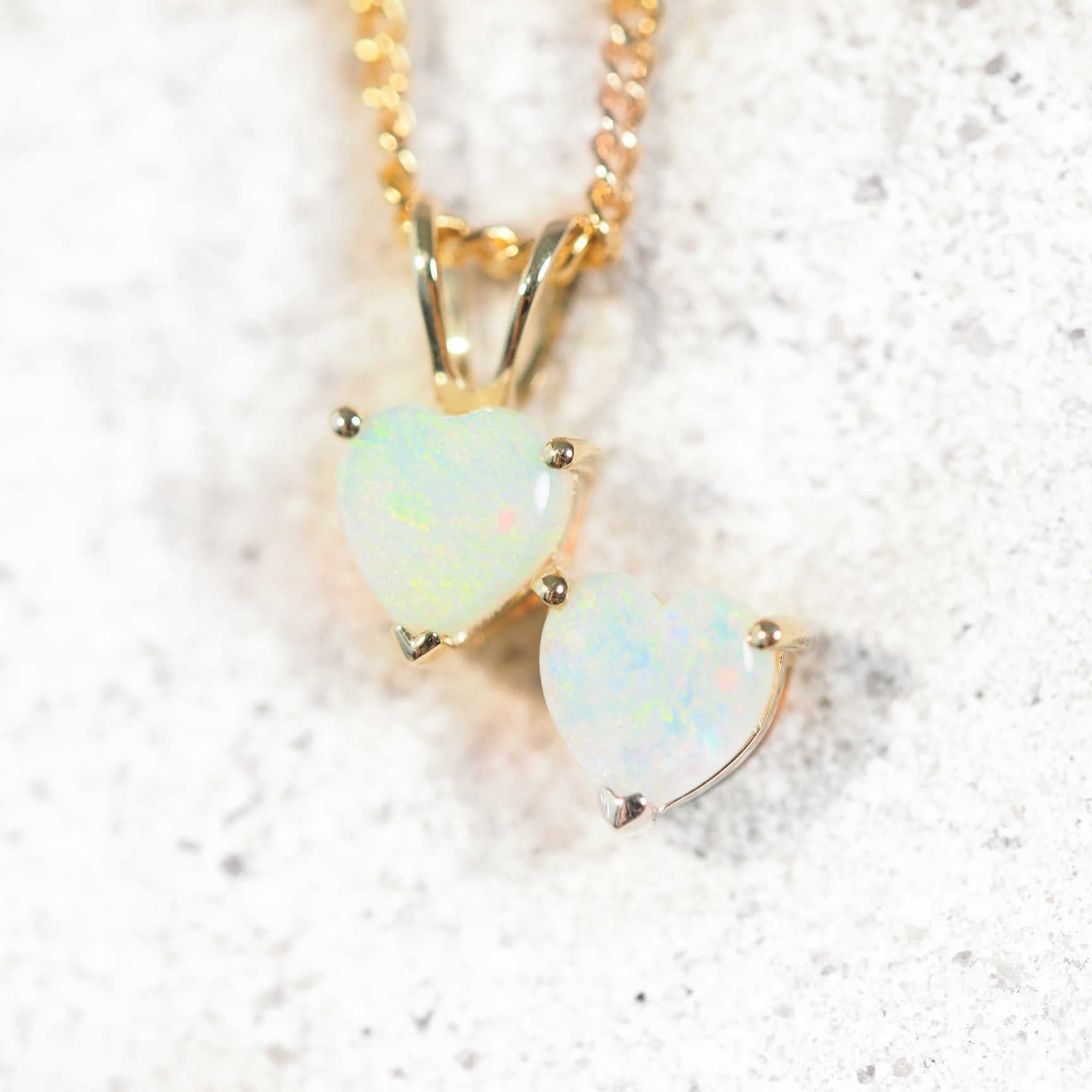 Double heart opal pendant in yellow gold with floral pattern