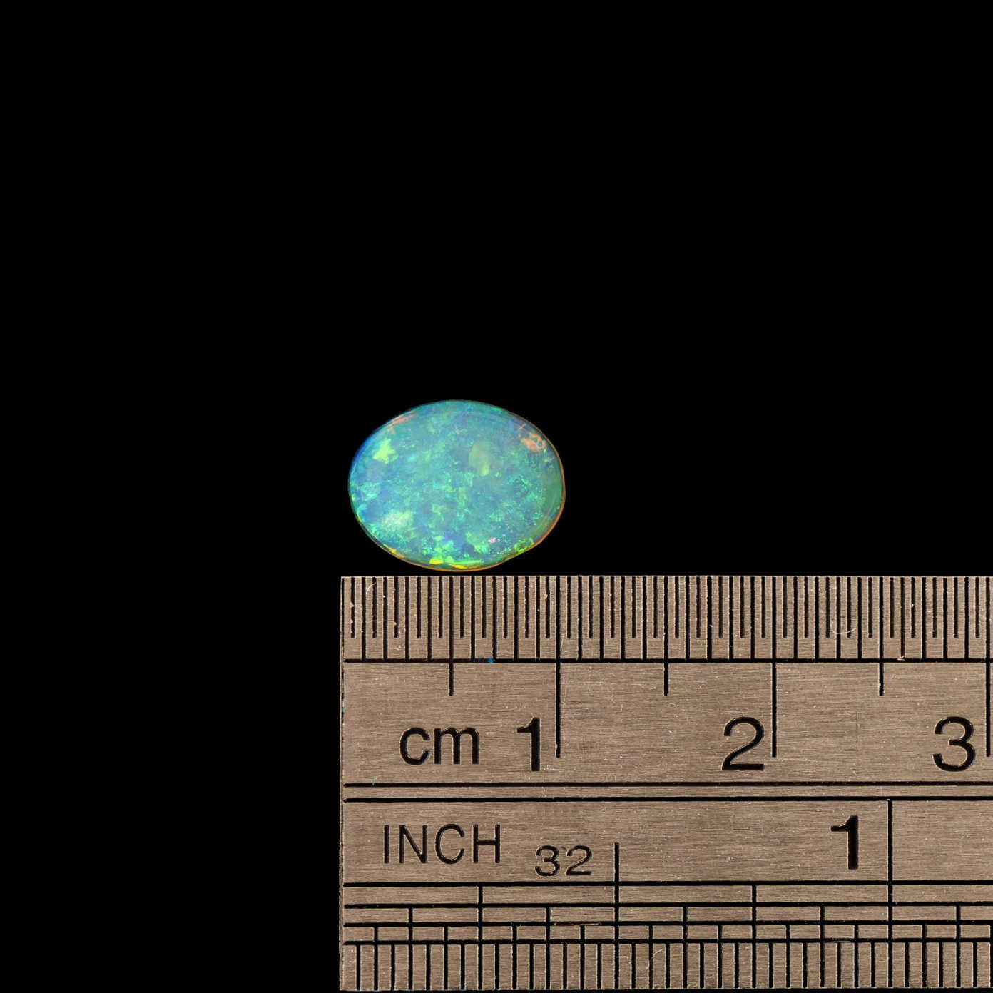 Natural Australian crystal opal displaying vivid green and gold hues