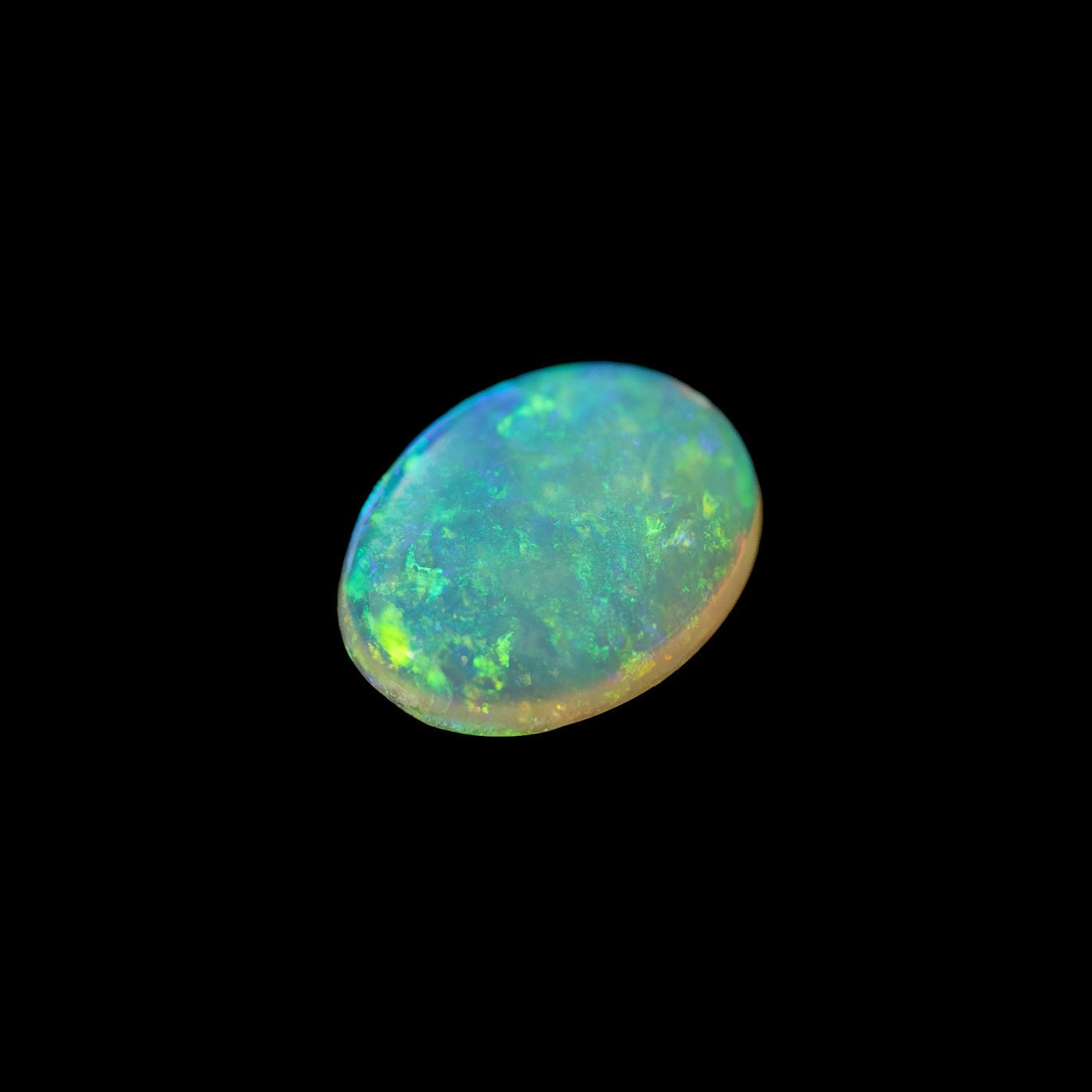 Solid crystal opal from Coober Pedy featuring vibrant green and gold colours