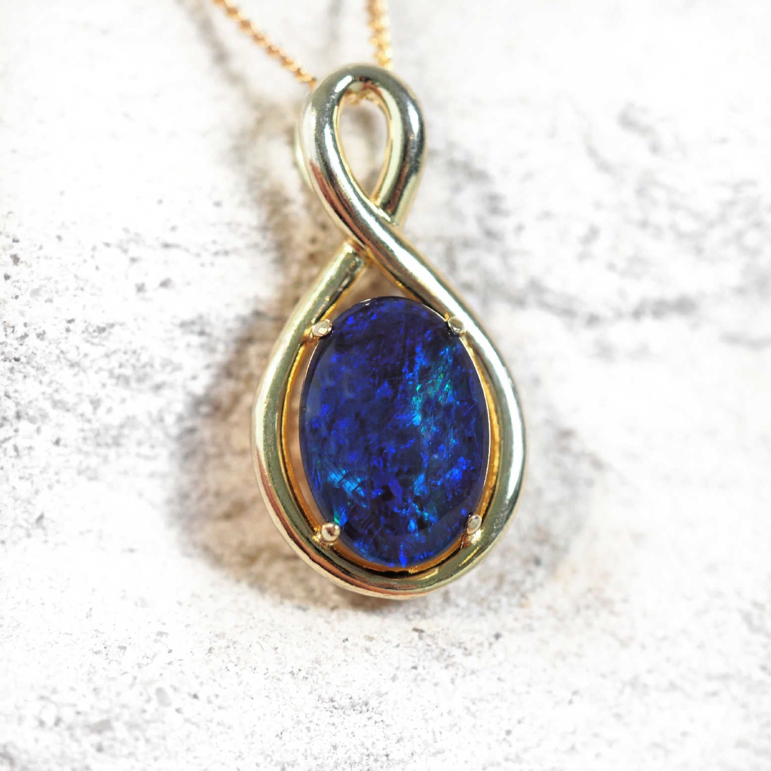 blue opal pendant set in yellow gold plated silver