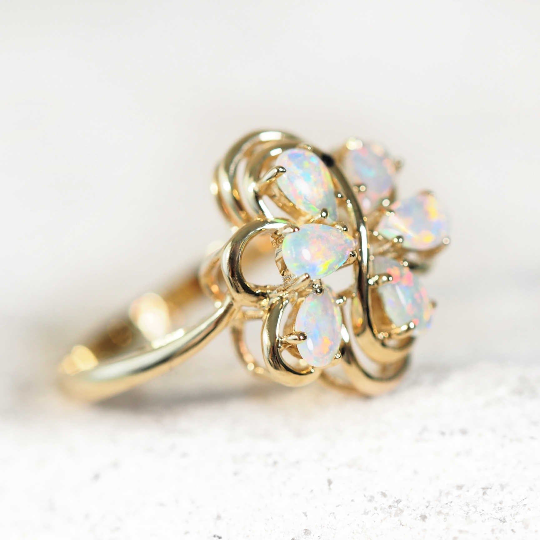six opal ring set in 14ct yellow gold