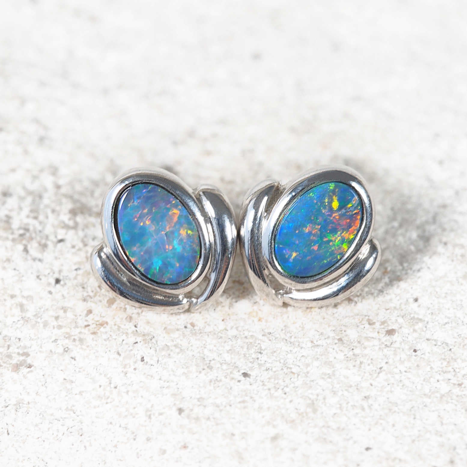 Multi-coloured opal earrings with bezel-set oval stones