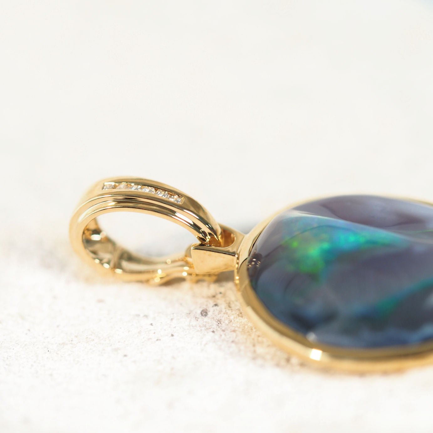 gold and diamond bail on a black opal pendant