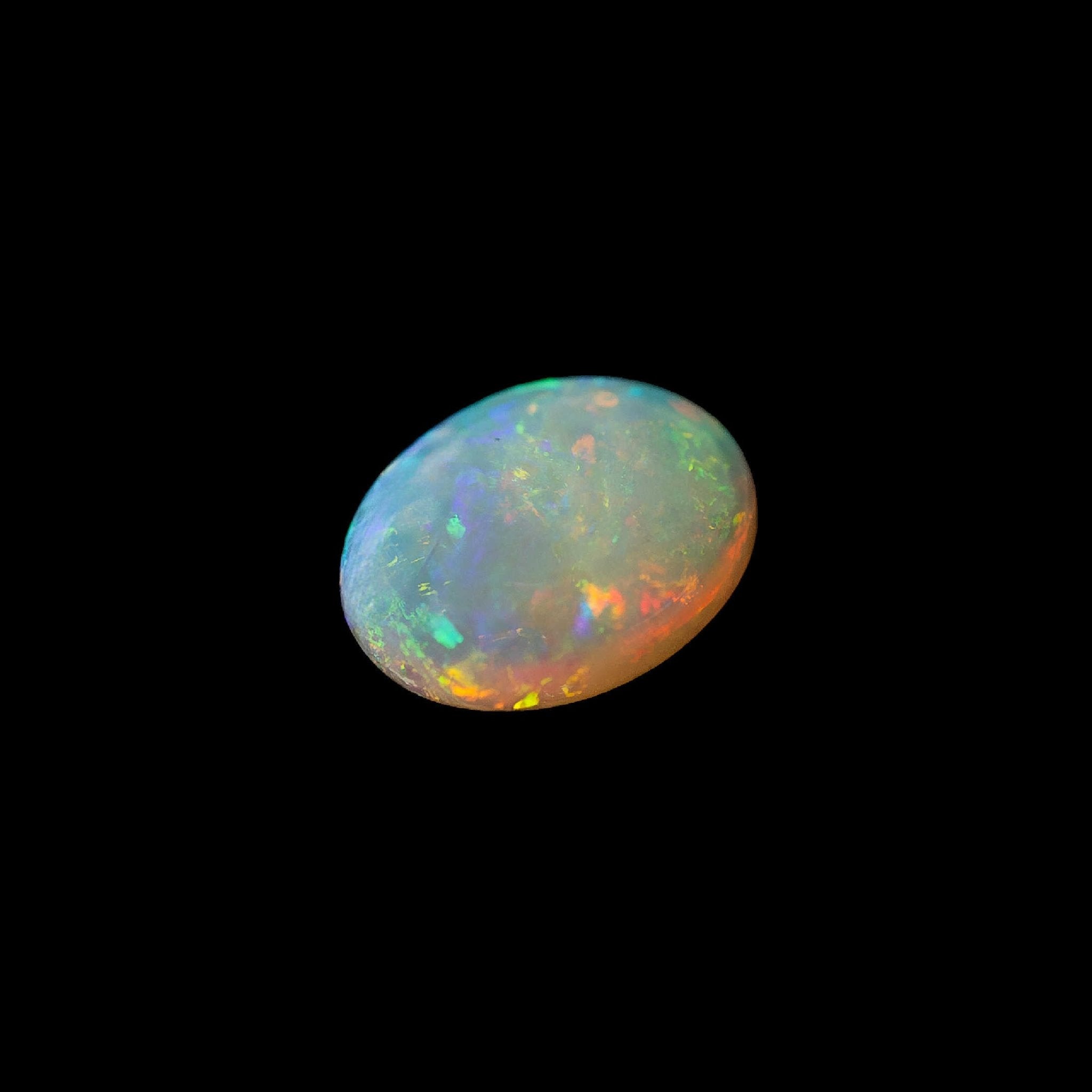 Multi-colored natural opal stone on a black background