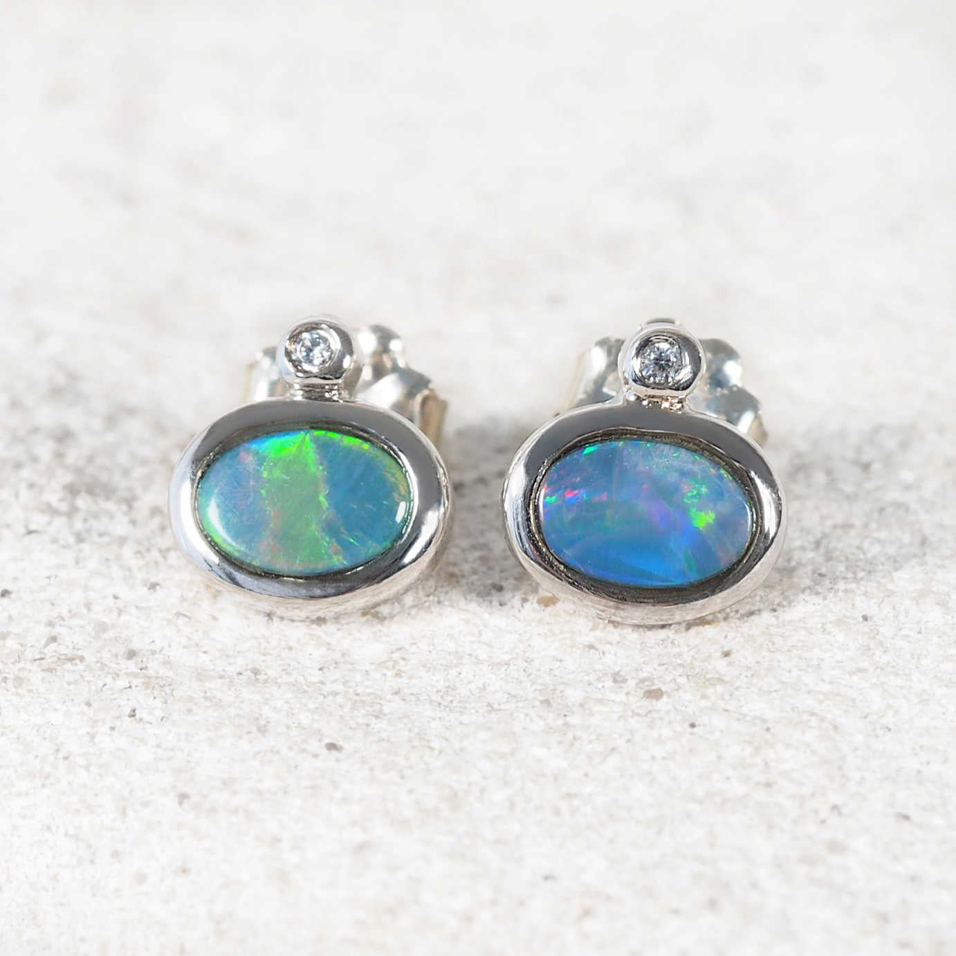 Sterling silver opal stud earrings featuring colourful Australian opals and sparkling cubic zirconia