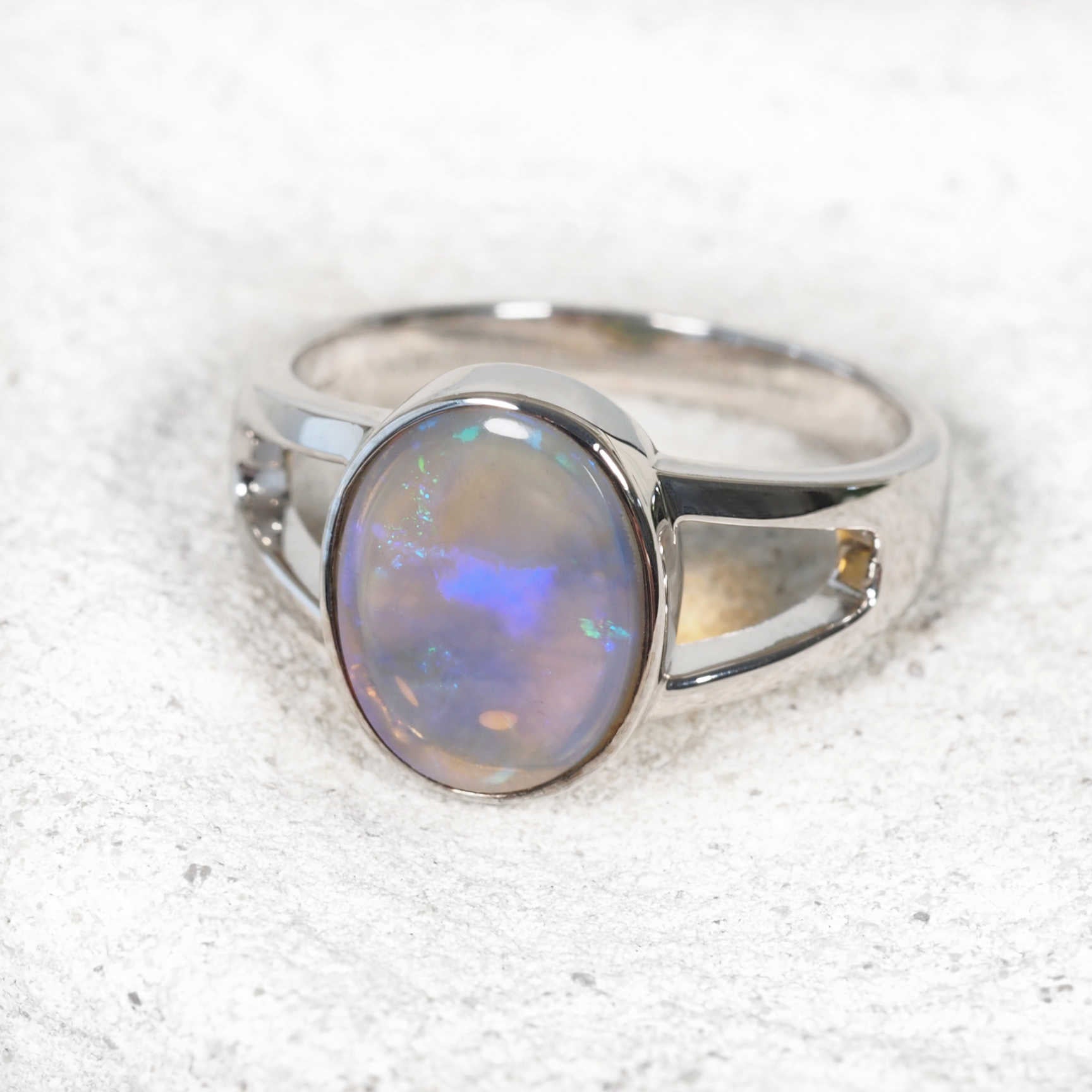 Contemporary opal ring showcasing blue, green and purple colour play