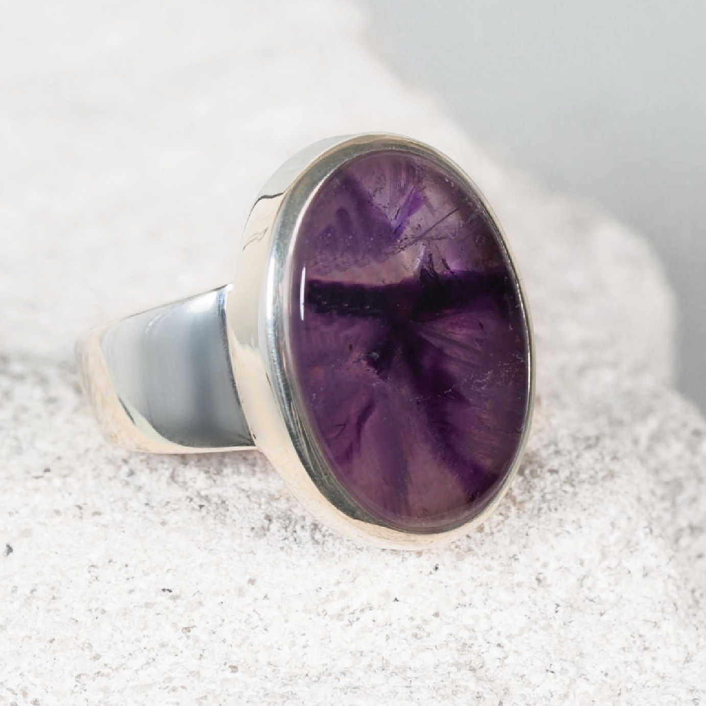 Crafted silver ring, ‘Kaylee,’ with a smooth oval amethyst cabochon featuring blended purple colours