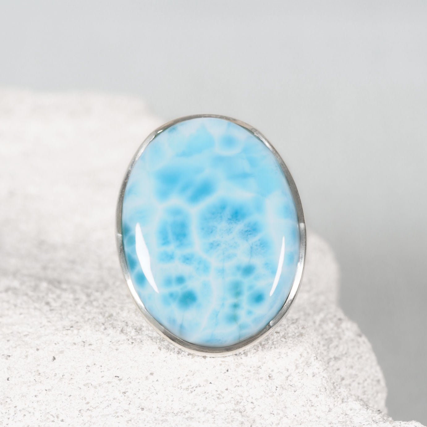 Larimar Gemstone ring set in silver displaying sky blue tones with white marbling design