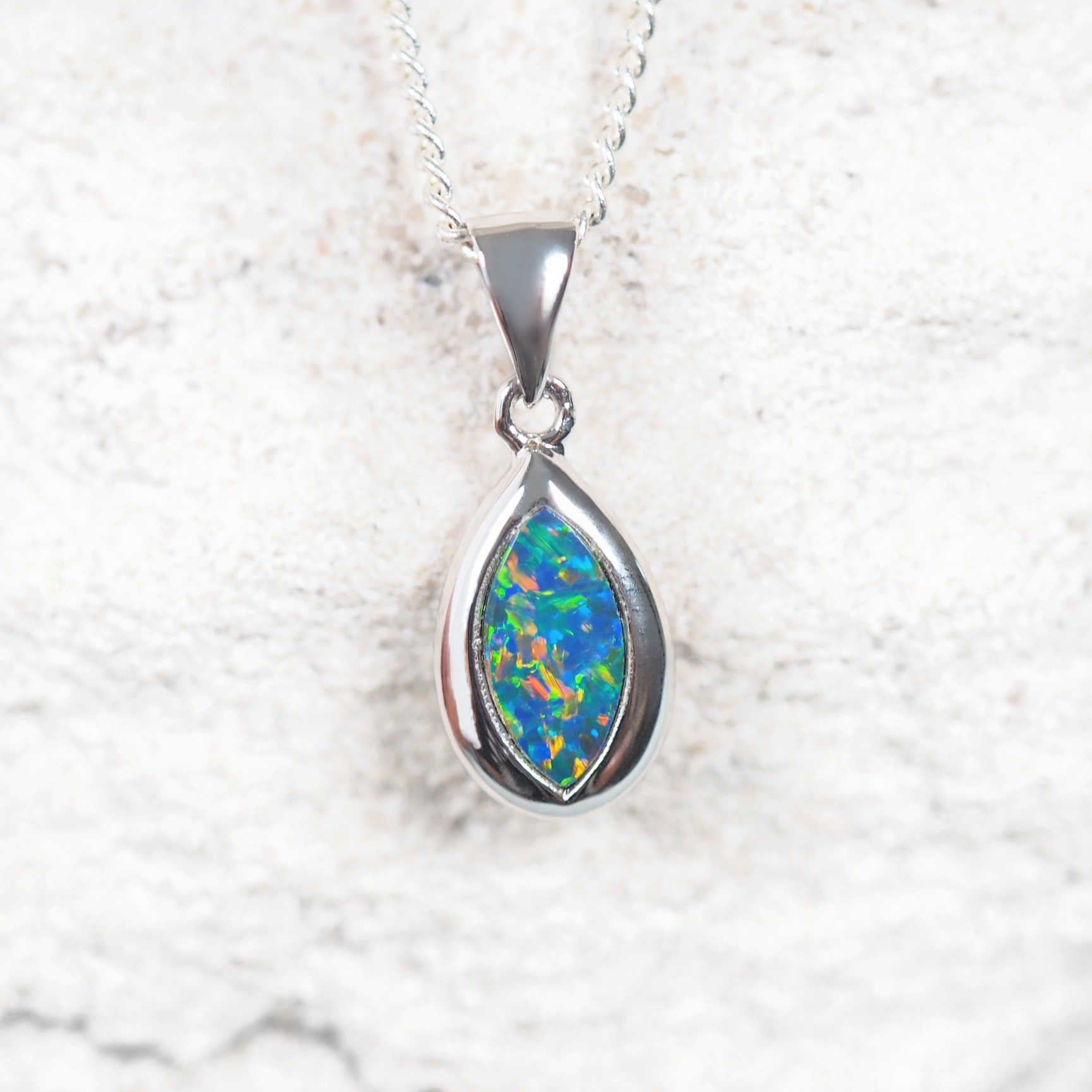colourful opal pendant set in white gold
