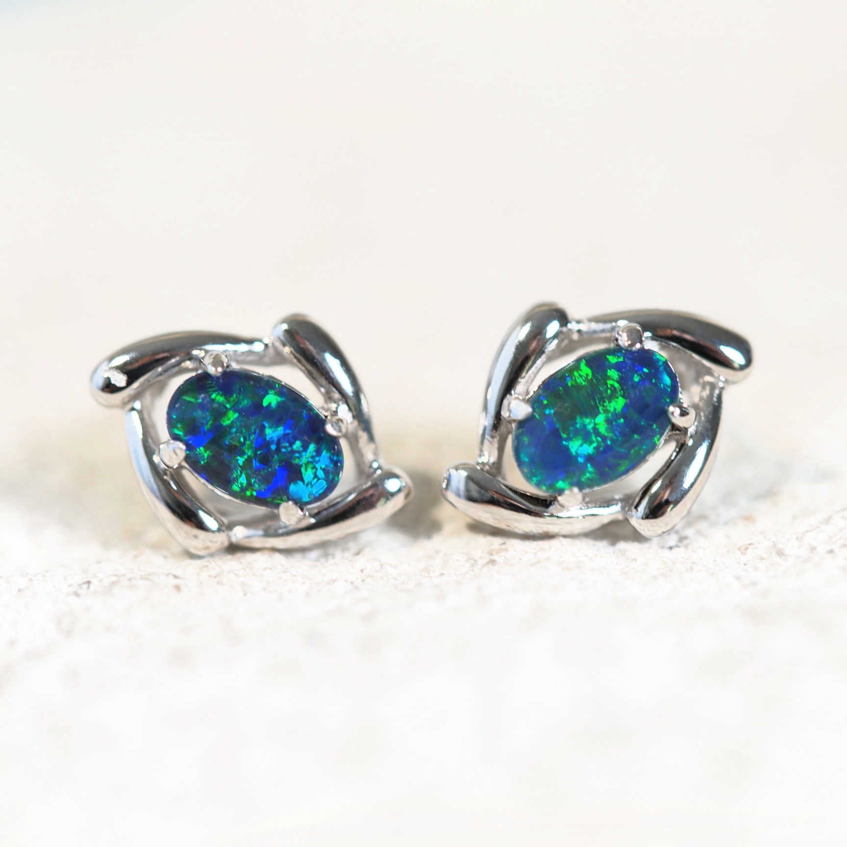blue and green opal earrings set in sterling silver studs