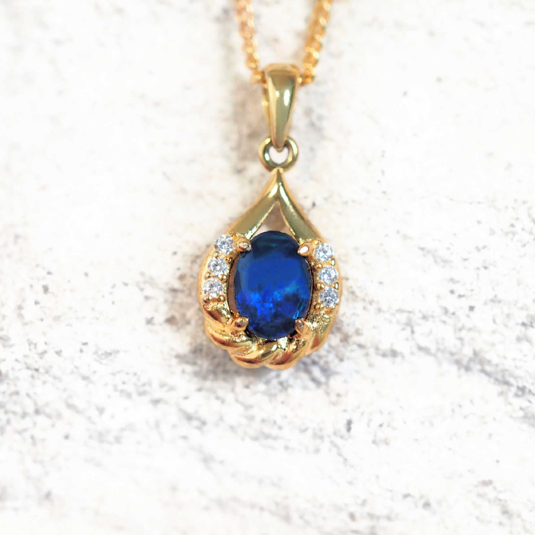 blue opal pendant with six cubix zirconias in gold plated silver