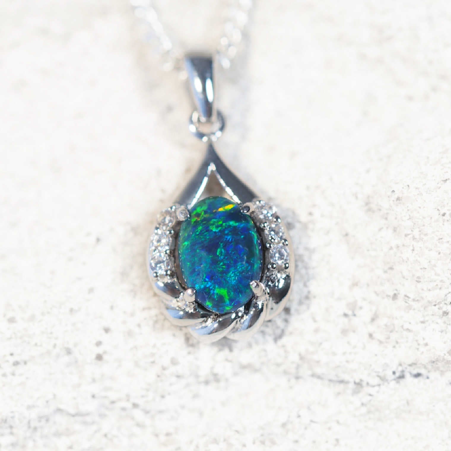 blue and green opal pendant set in sterling silver with six sparkling diamantes