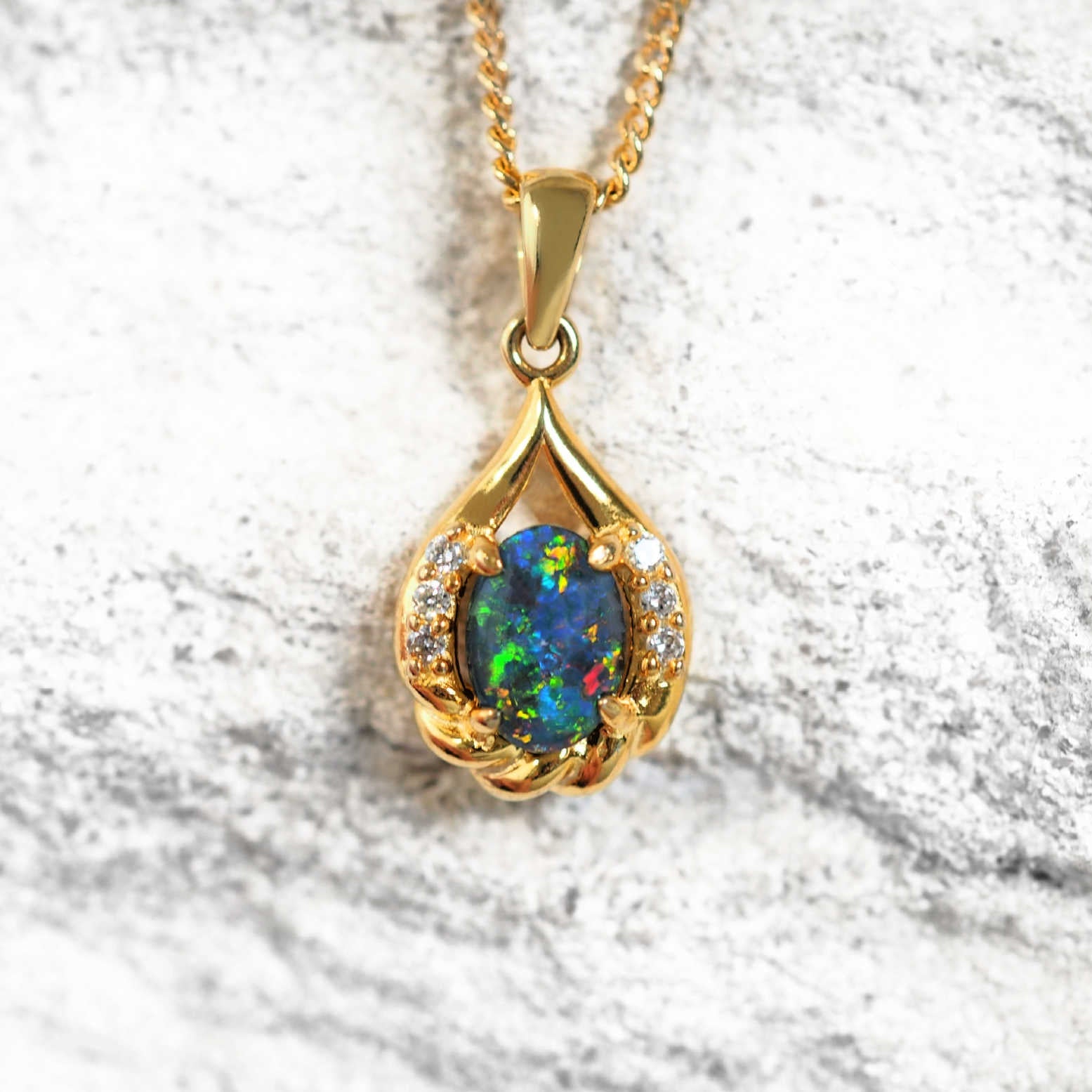 Gold plated silver opal pendant with multi-coloured oval triplet opal and six cubic zirconias