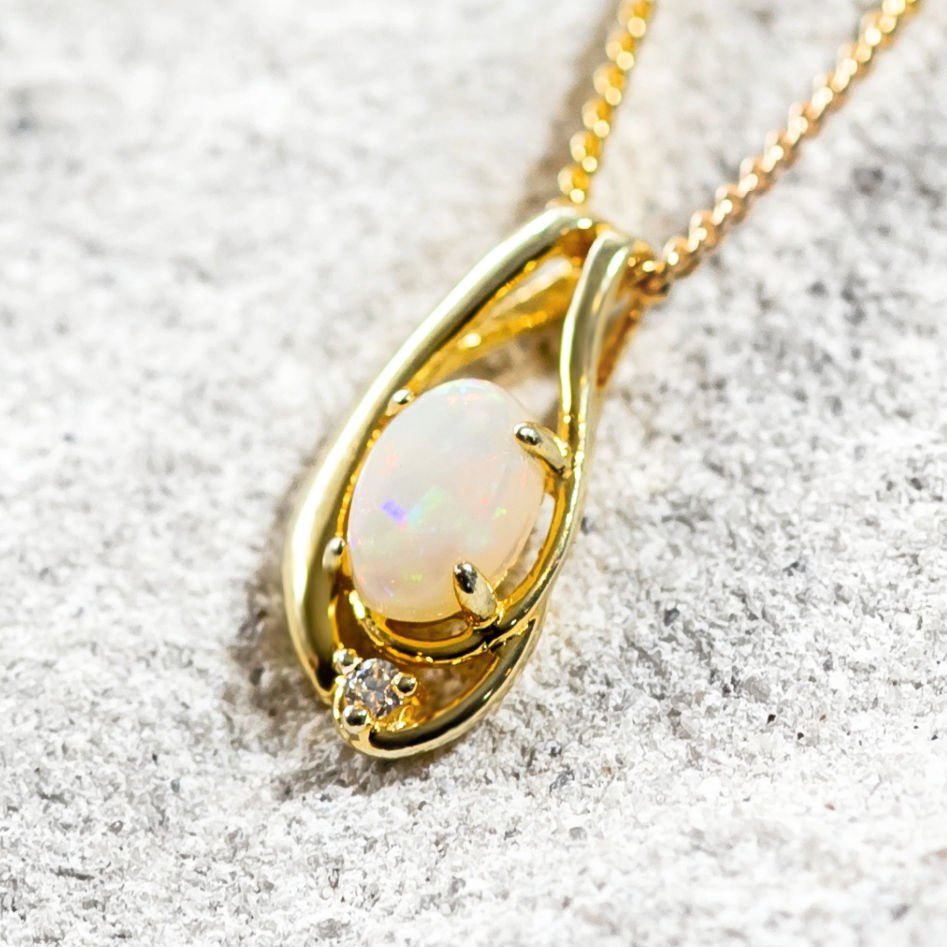 white opal pendant set in gold plated silver