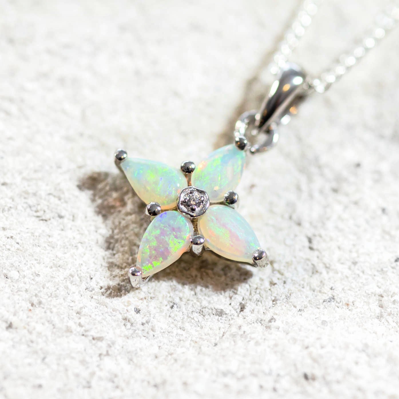 four green opals set into a silver pendant