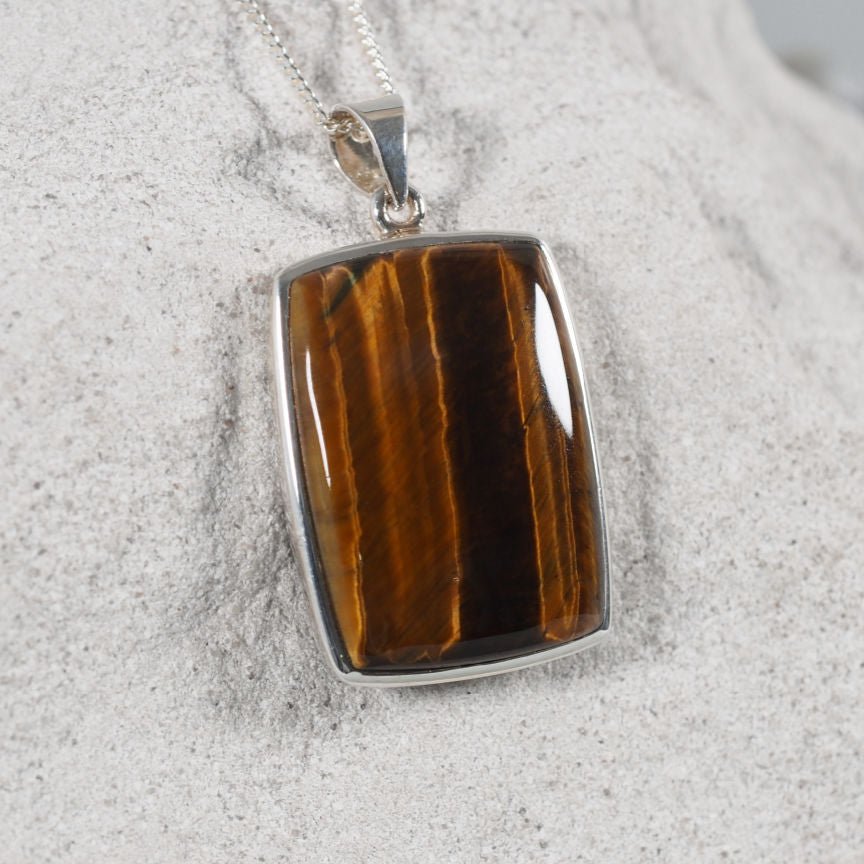 Lila pendant featuring polished brown Tiger’s Eye in a silver setting