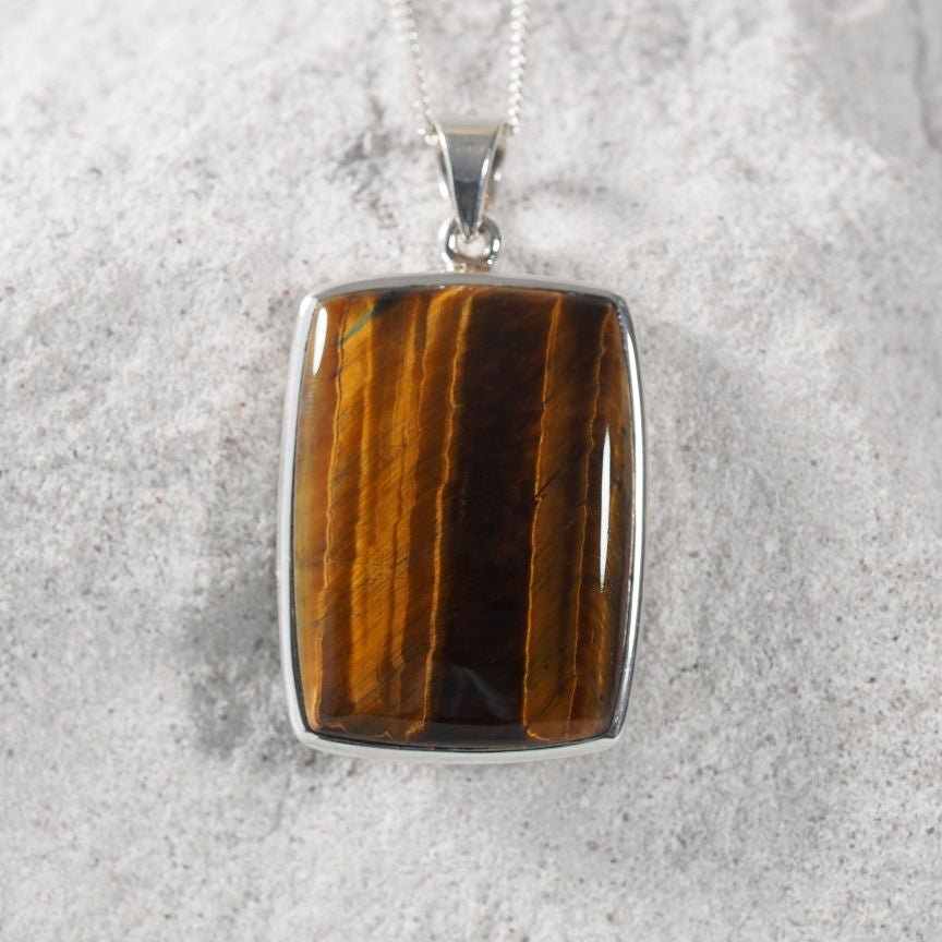 Square Tiger’s Eye cabochon pendant set in sterling silver.