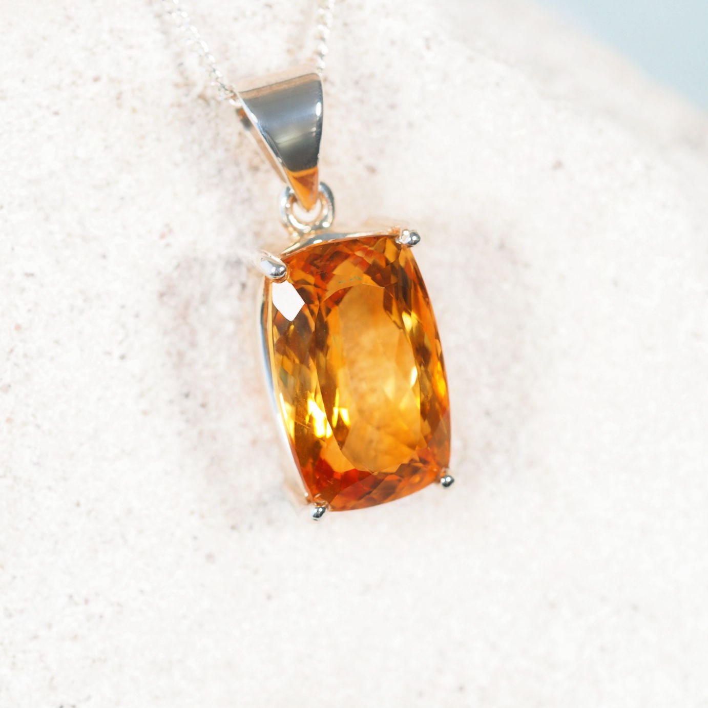 Close-up of 'Liora' pendant showcasing faceted Brazilian Citrine set in a polished silver frame