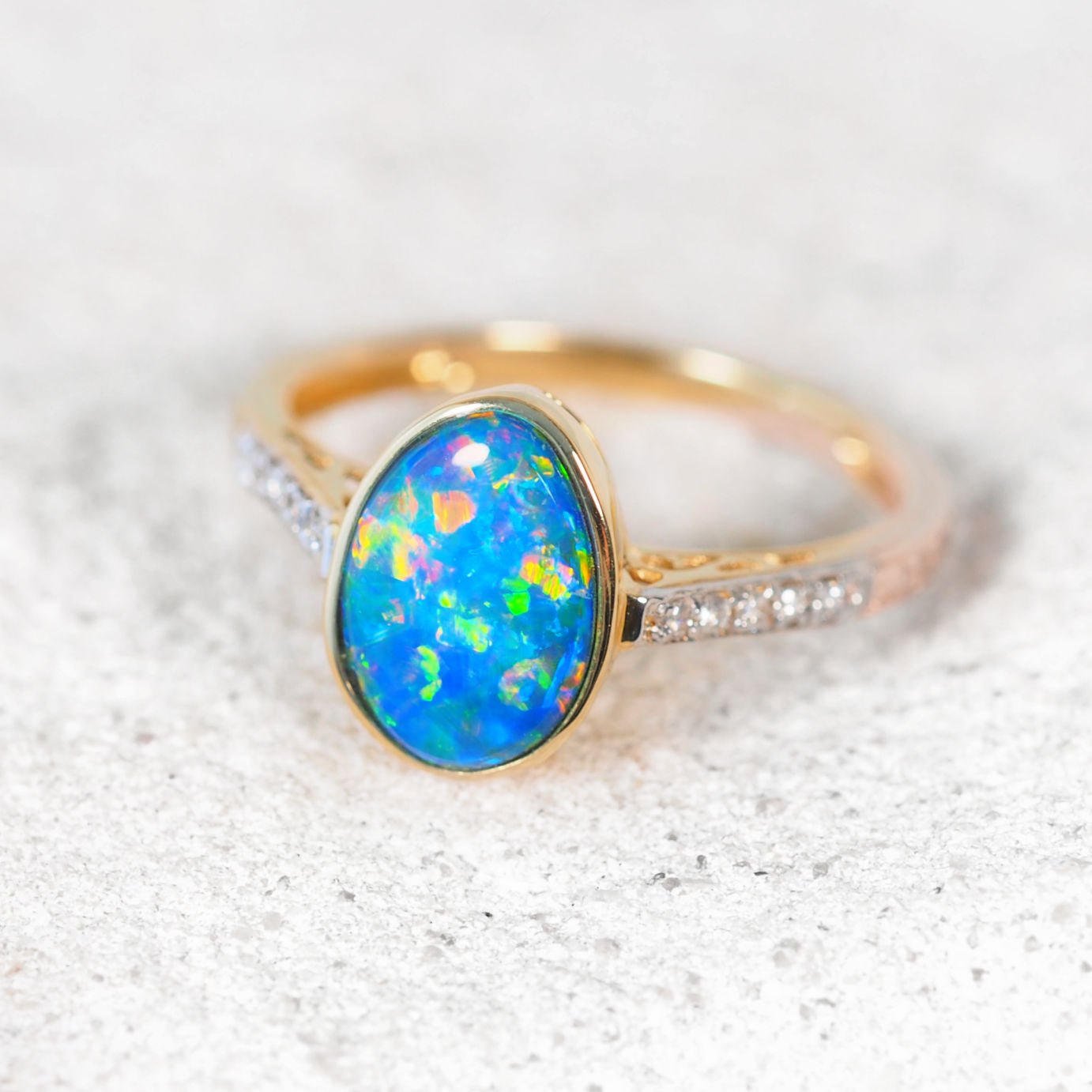 Elegant 14ct yellow gold opal and diamond ring showcasing the oval Australian doublet opal – Liora design