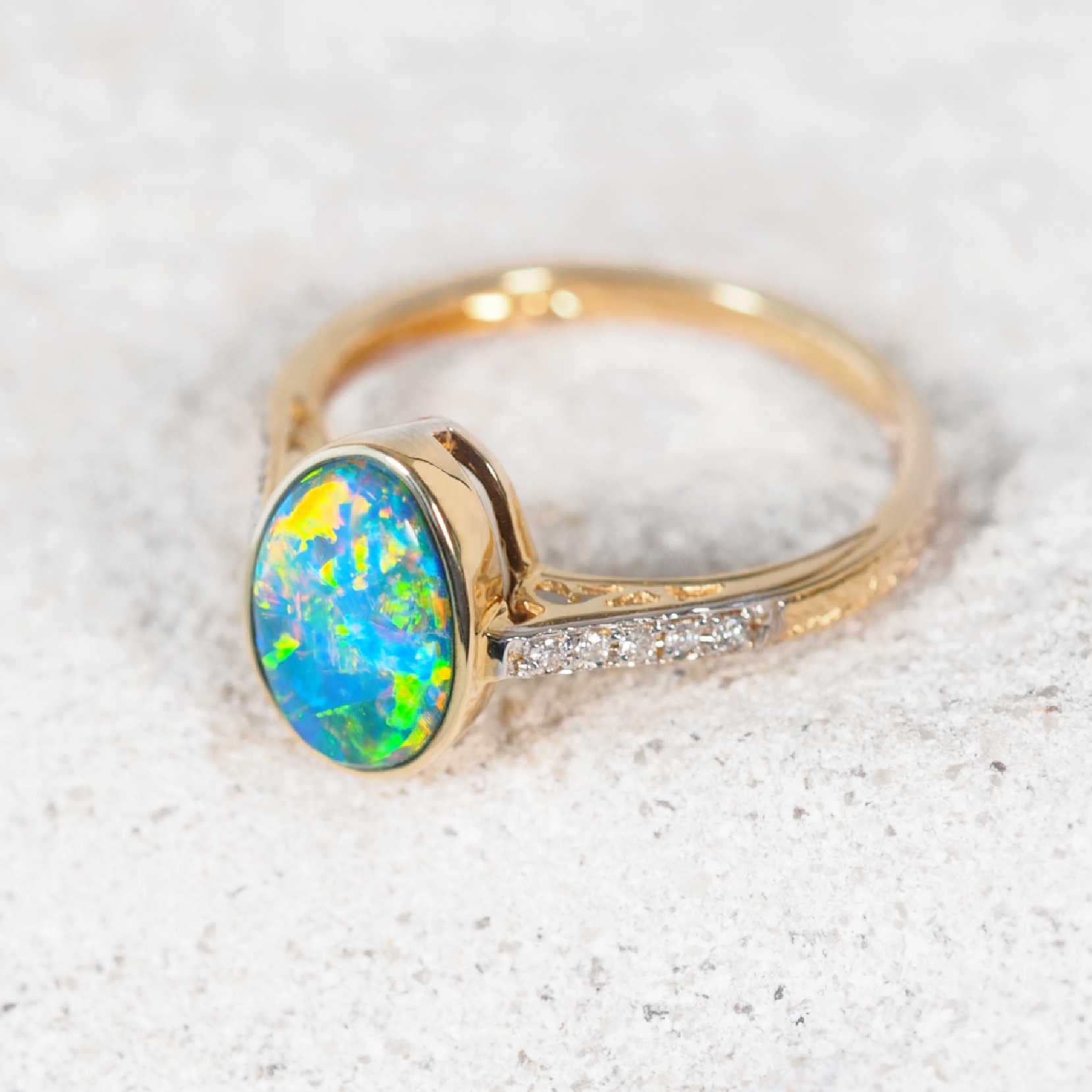 Oval Australian doublet opal ring with diamond accents set in 14ct yellow gold – Liora jewellery piece
