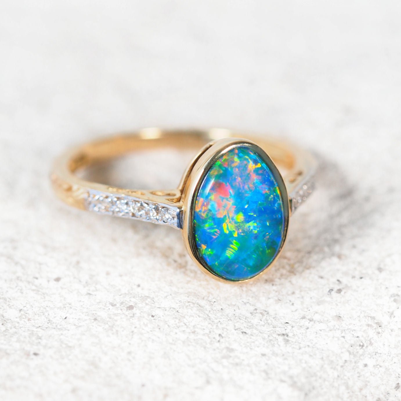 Liora opal ring in 14ct yellow gold featuring oval Australian doublet opal with sparkling diamond shoulders