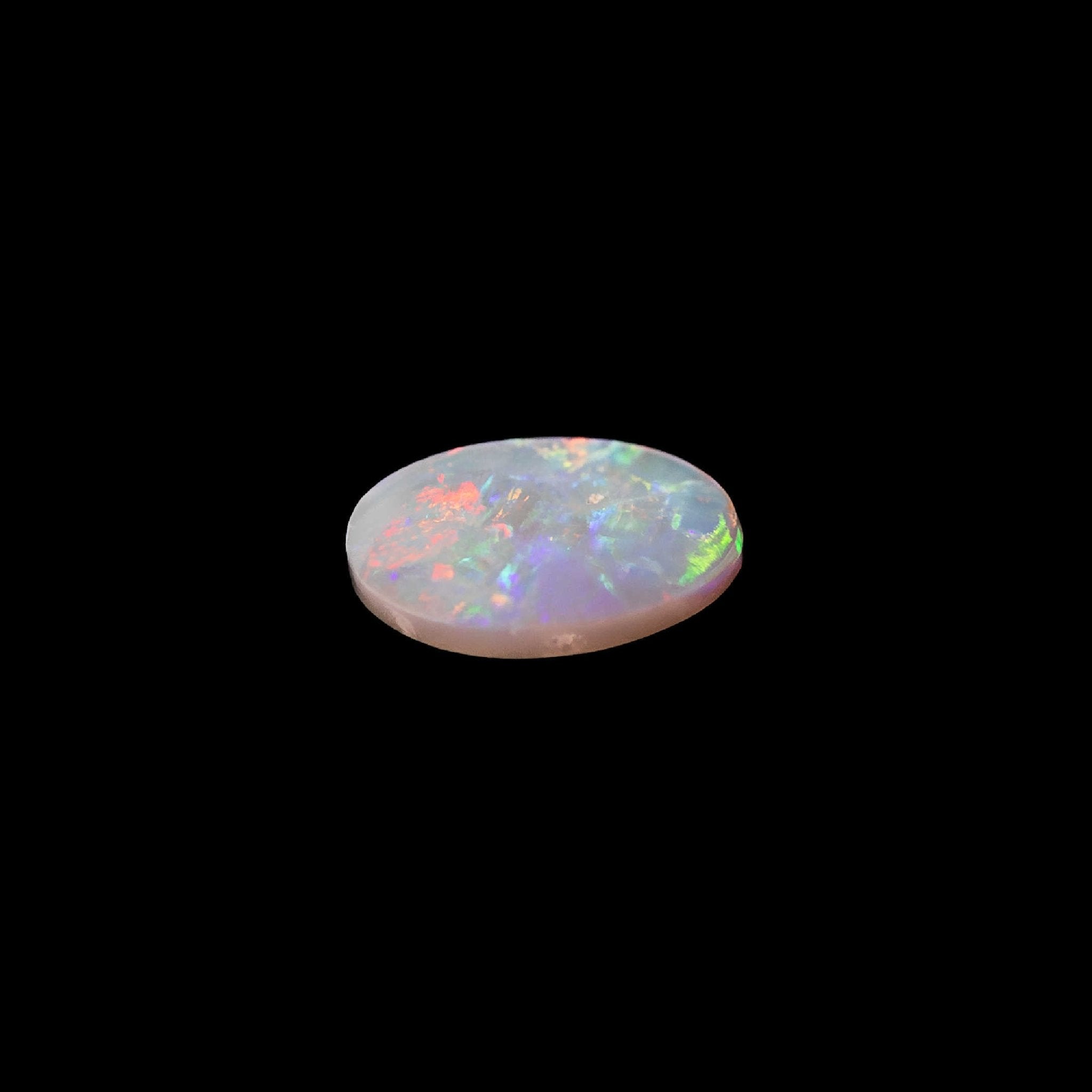 Vivid oval crystal opal from Lightning Ridge, featuring brilliant hues and a translucent body tone that amplifies the colour play