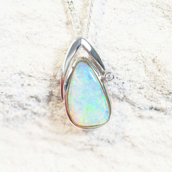 green crystal opal pendant set in white gold with one sparkling diamond