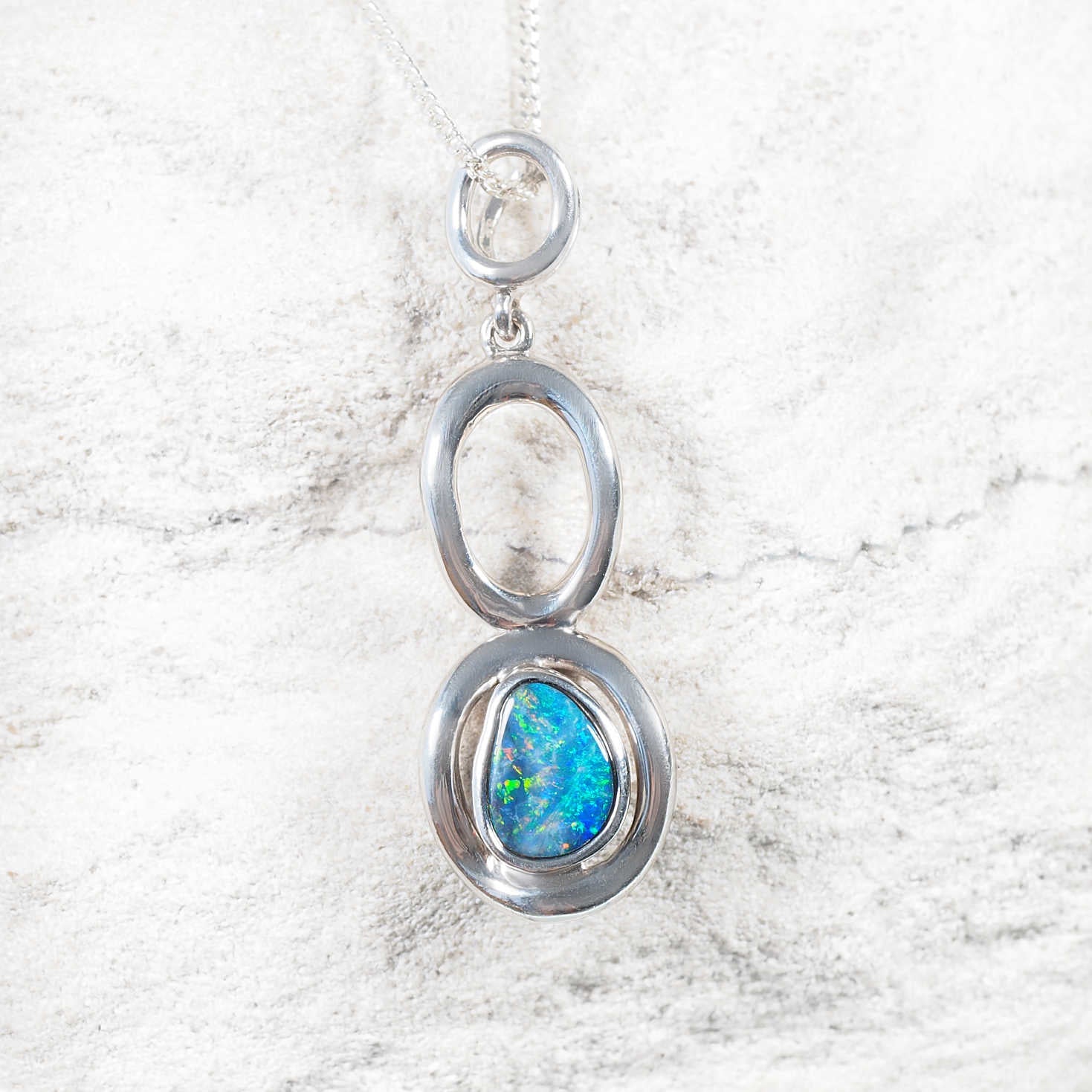 Lolia opal necklace with bezel-set freeform Australian opal in modern halo drop design