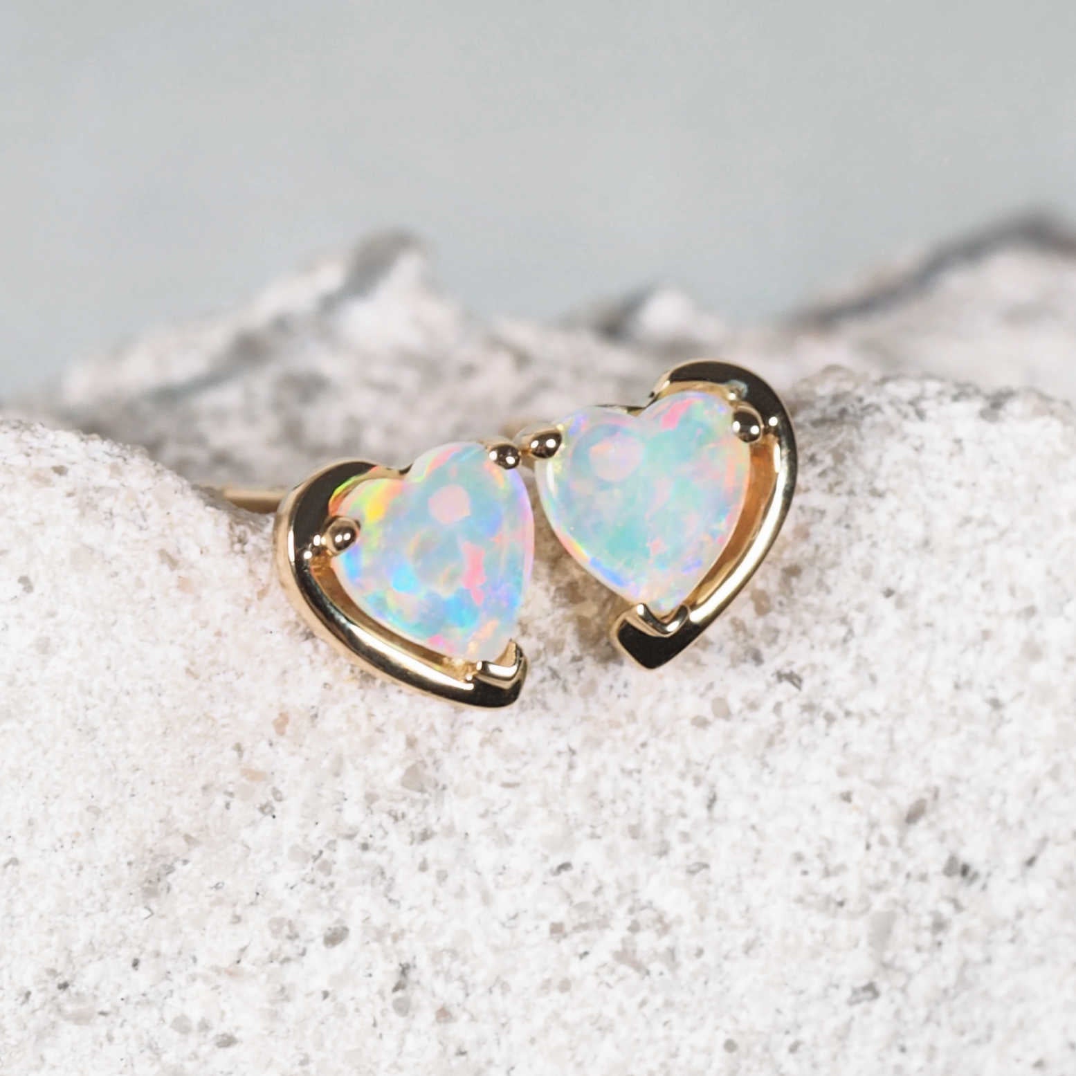 Heart-shaped solid crystal opal earrings in 14ct yellow gold