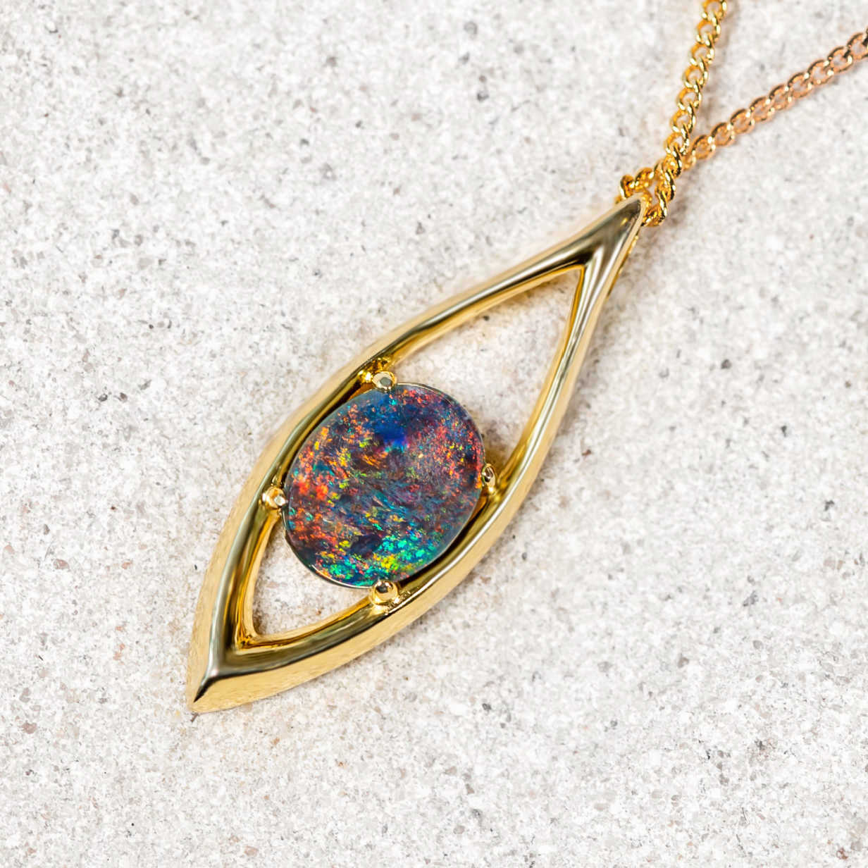 Beautiful marquise-shaped gold plated sterling silver necklace pendant claw set with a brilliant multi-coloured round-oval Australian triplet opal.