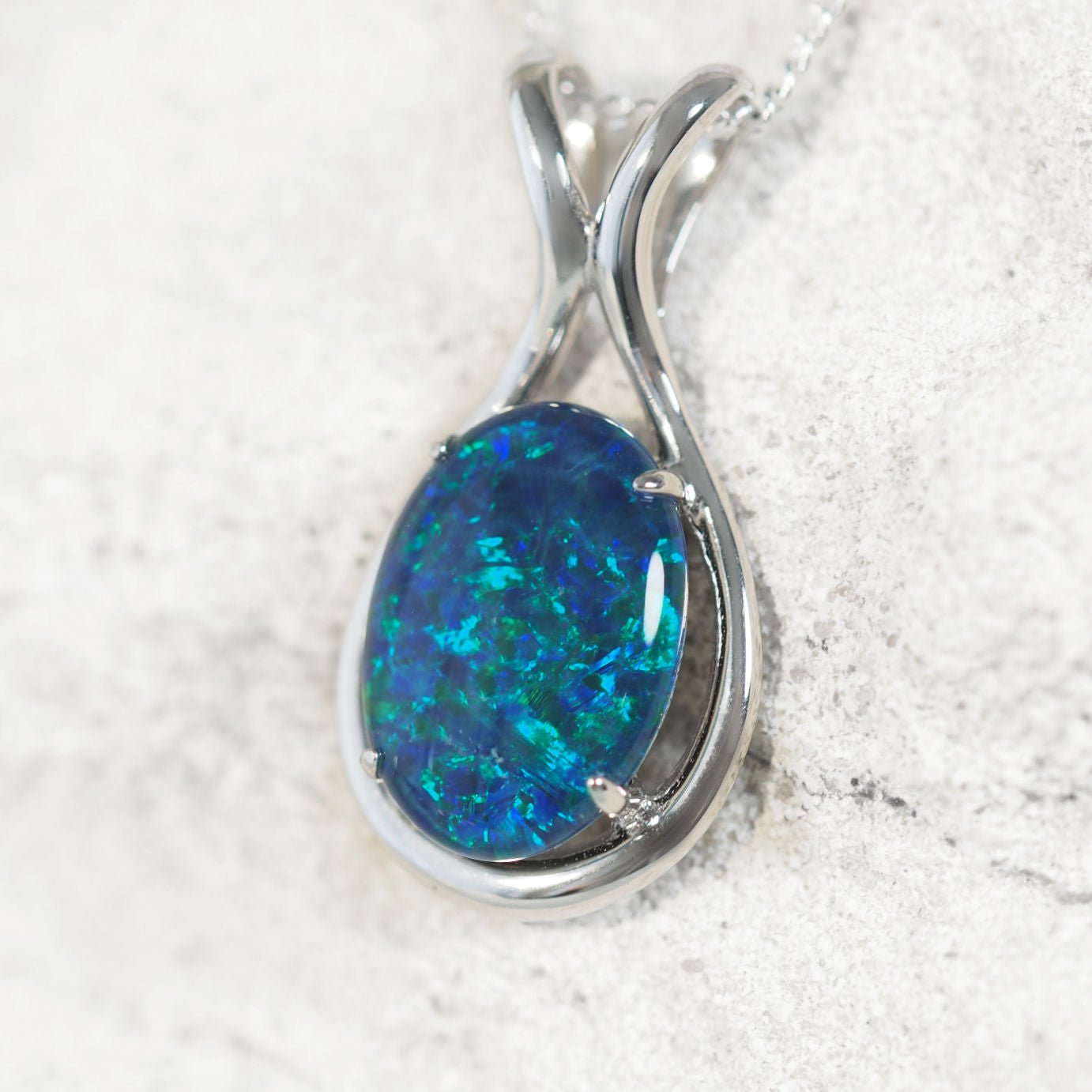 Sterling silver opal necklace pendant featuring claw-set blue and green Australian triplet opal with natural play-of-colour