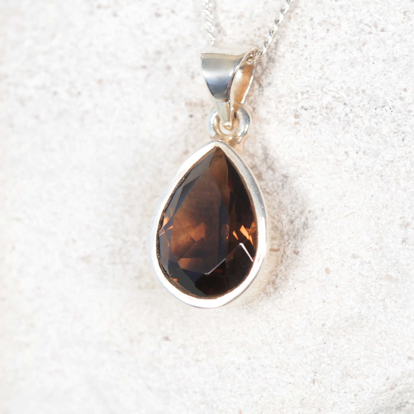 Petite teardrop Smokey Quartz pendant in polished silver bezel, highlighting warm brown facets