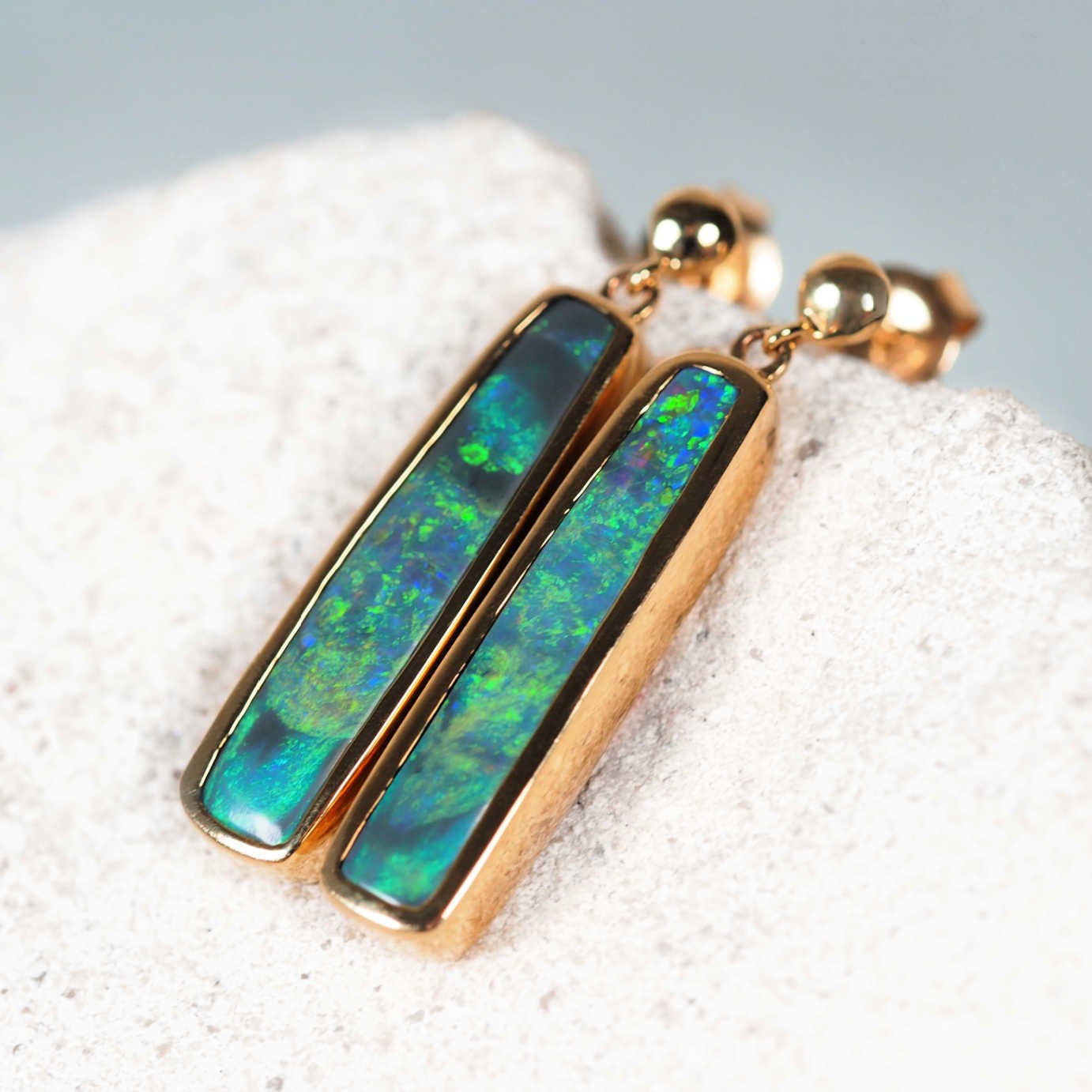 Elegant 14ct yellow gold rectangular black opal studs with bright green and blue tones – Margareta design