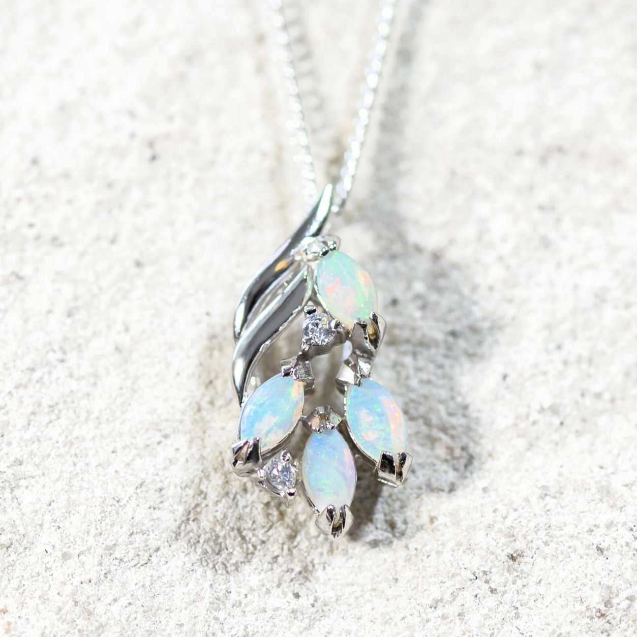 four blue opals set into a silver pendant