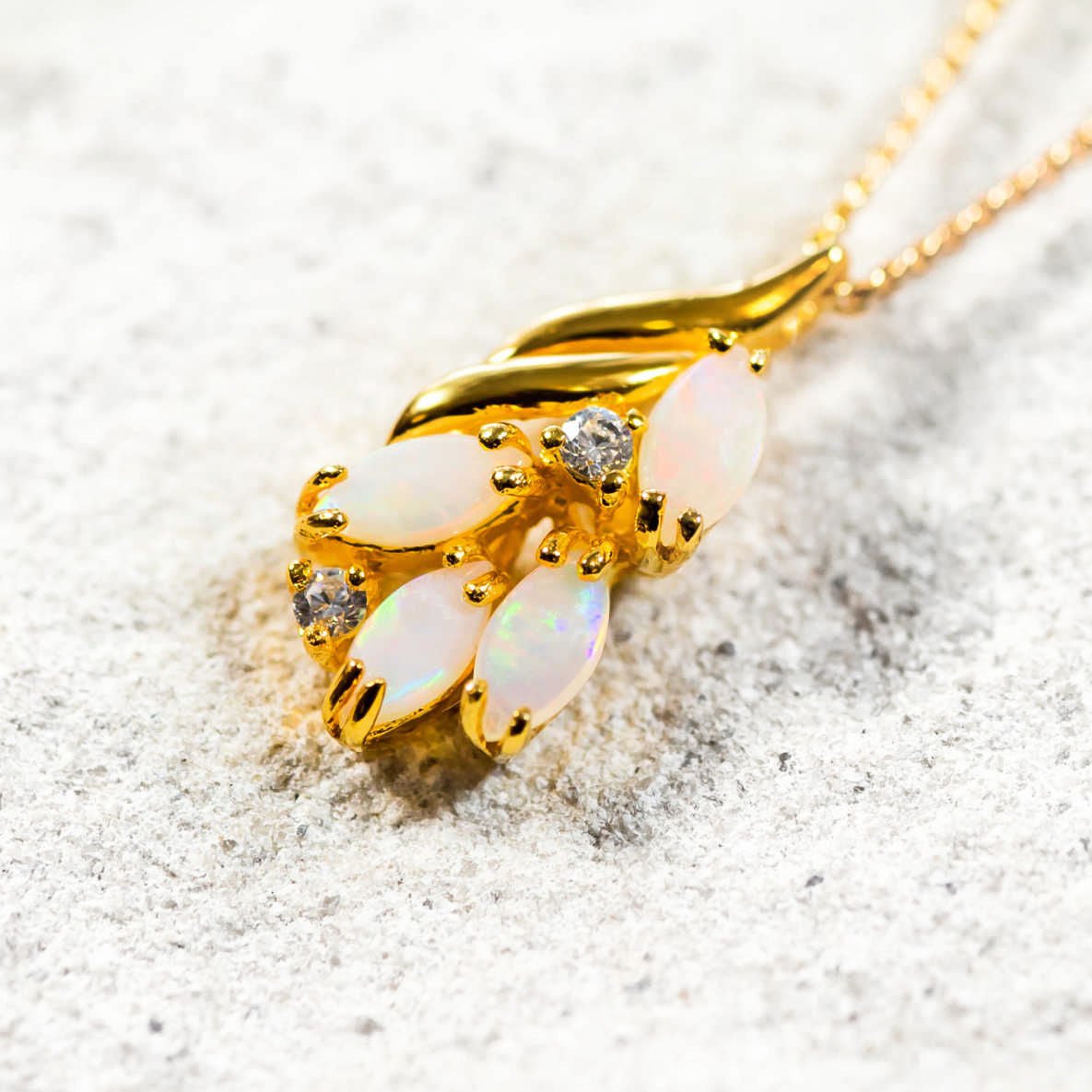 four marquise shaped white opals set into a pendant