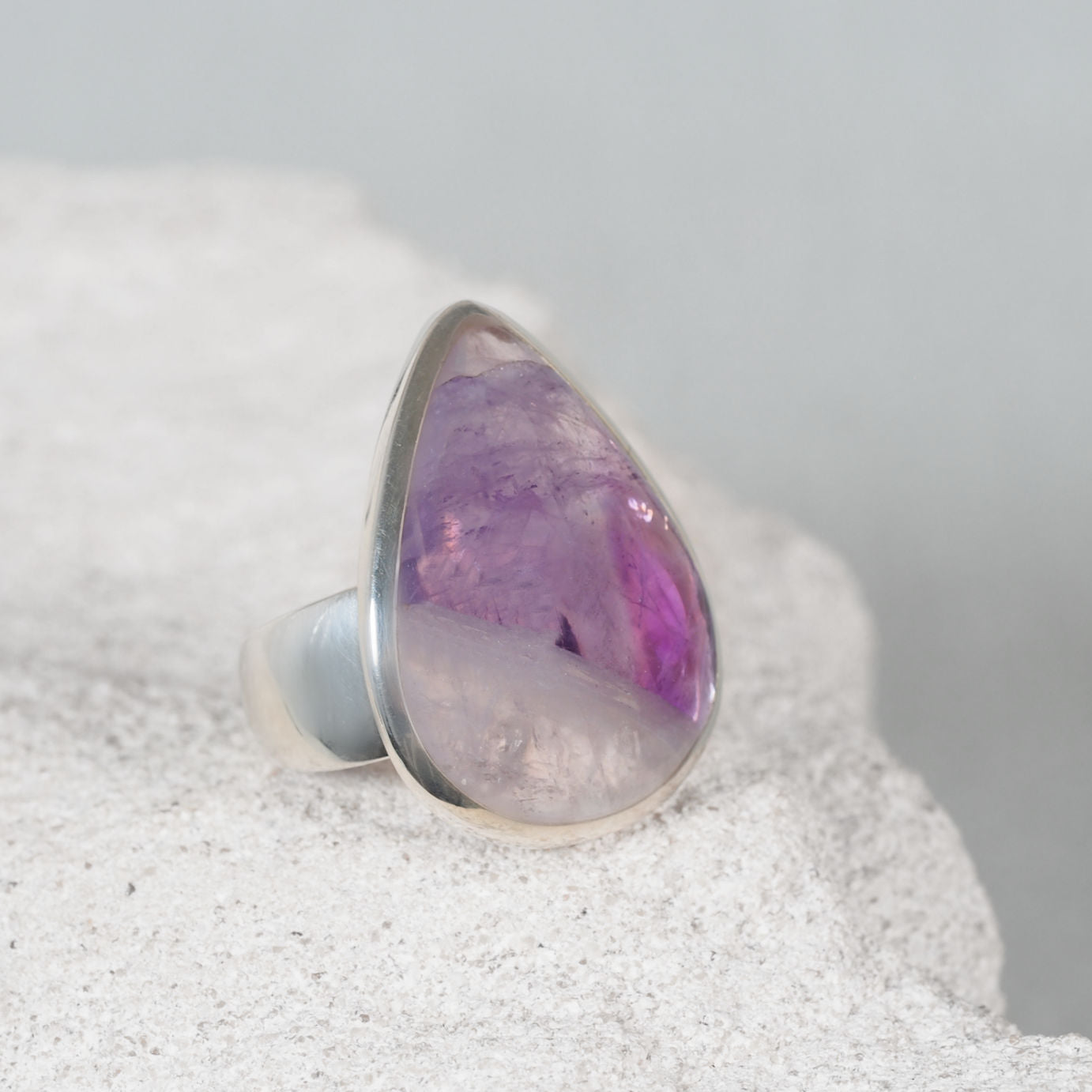 The ‘Mary’ silver ring with a teardrop triangular amethyst cabochon, light purple with a small clear section
